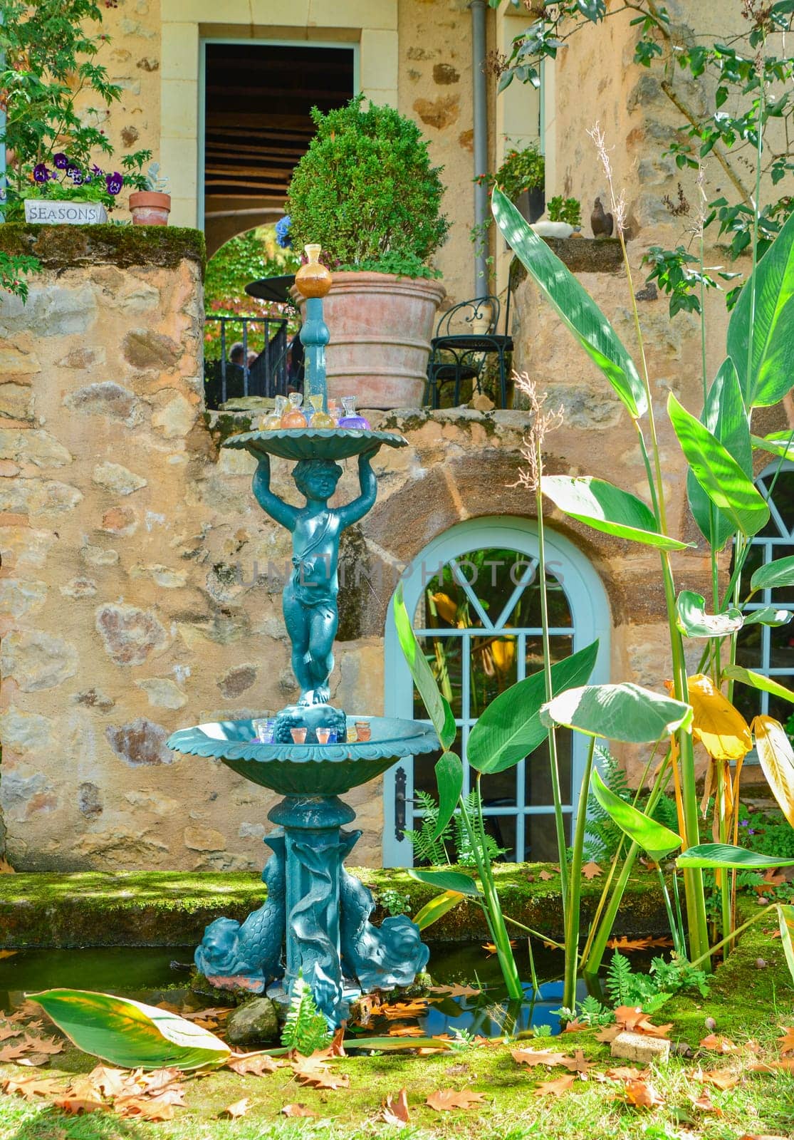 Sculpture of a child with fountain. Fountain statue in a garden