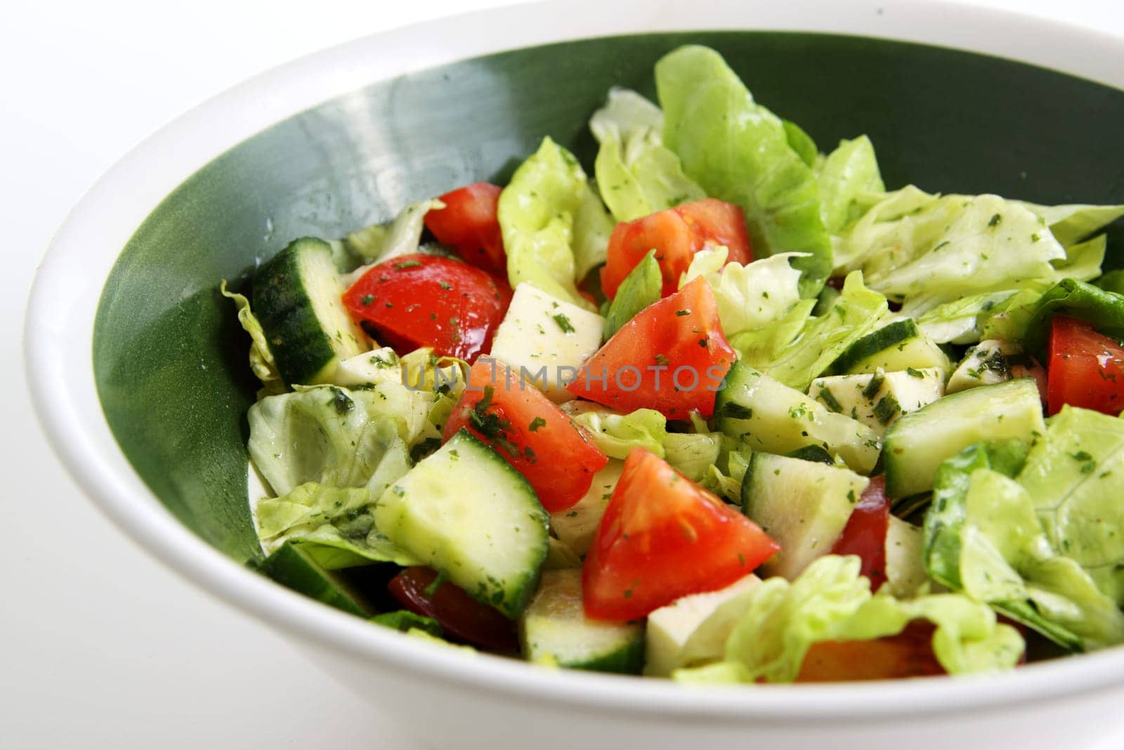 mixed green salad with tomato,cucumber and sheep's cheese