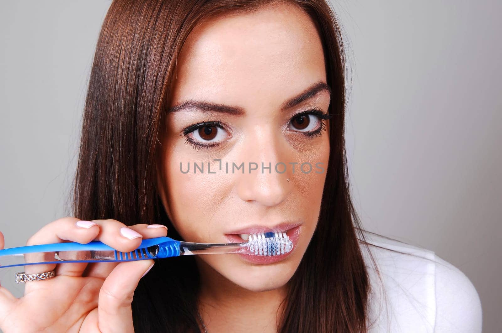 Woman brushing her teeth.