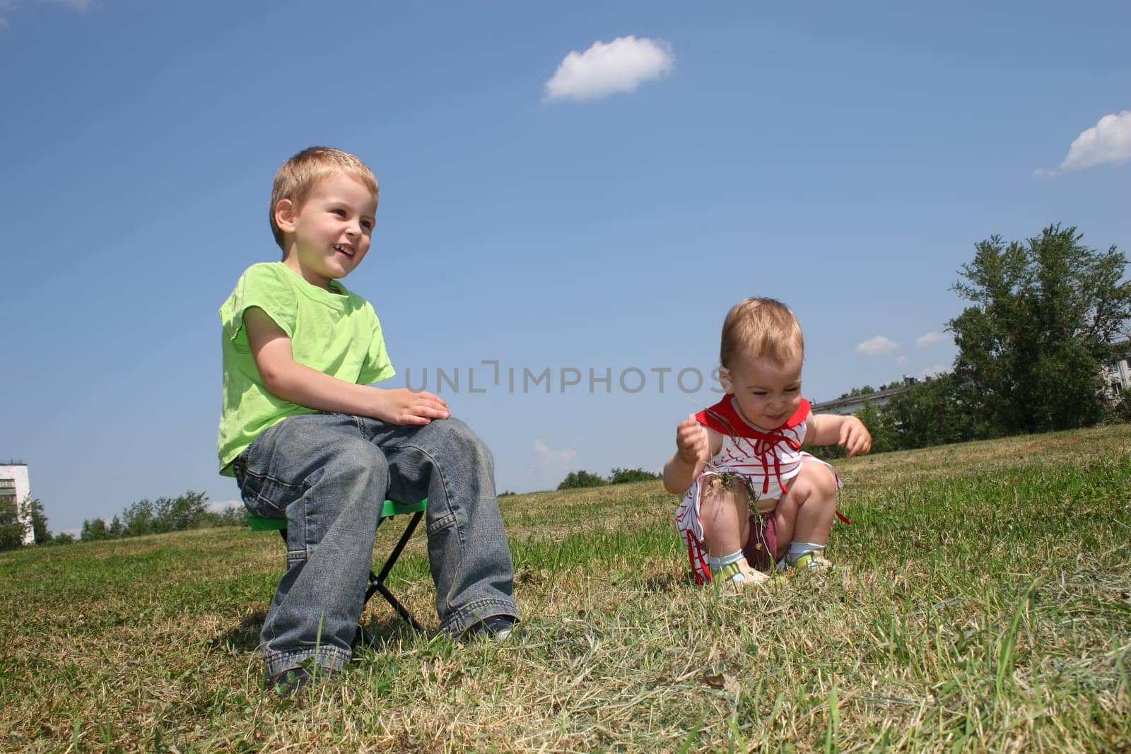 baby and child on meadow