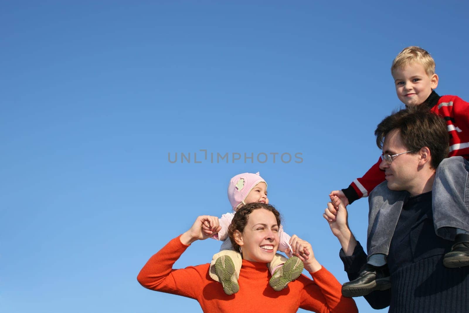 family with children on shoulders