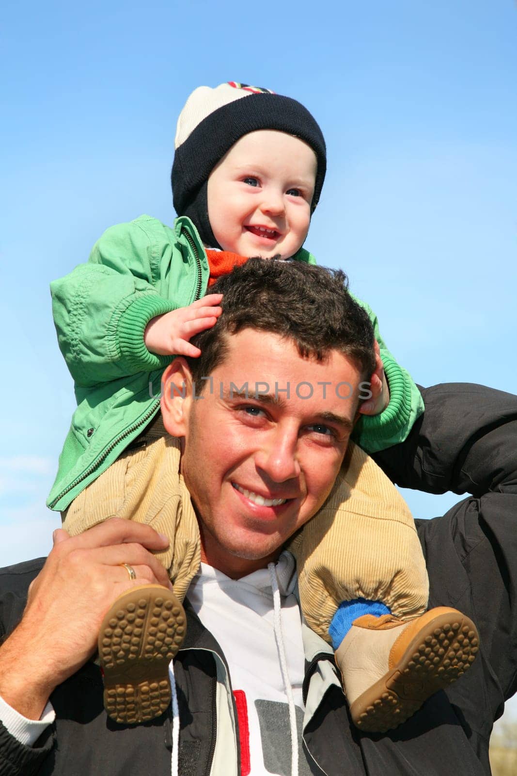 baby on father's shoulders
