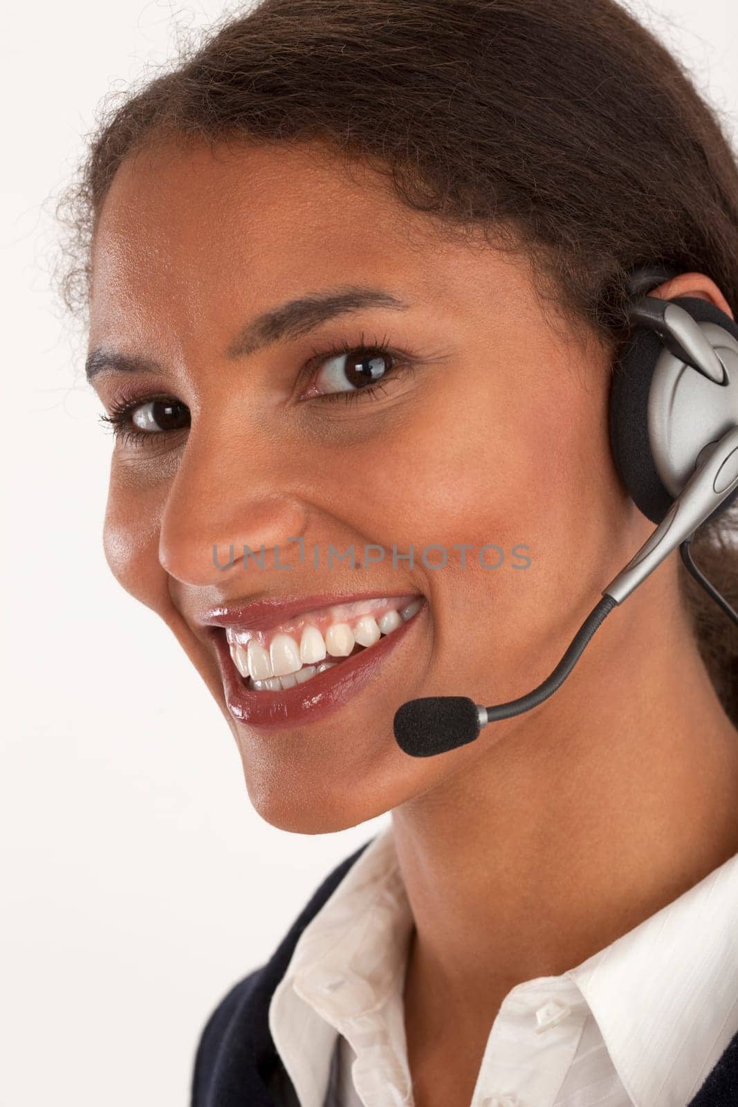 Closeup of young businesswoman wearing headset. Vertically framed shot.