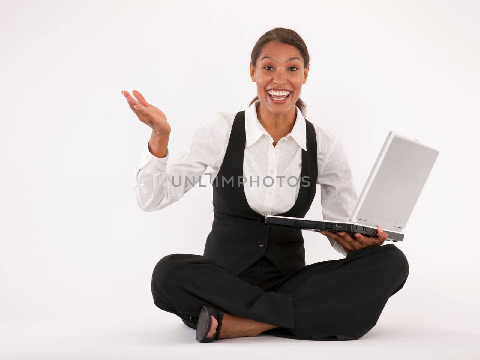 Young woman sitting on floor using laptop. Horizontally format.