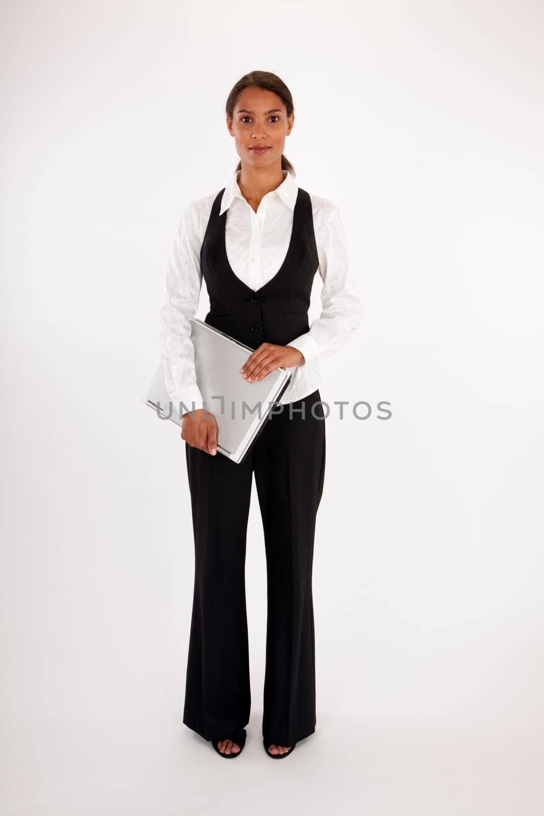 Young woman holding laptop computer. Vertically framed shot.