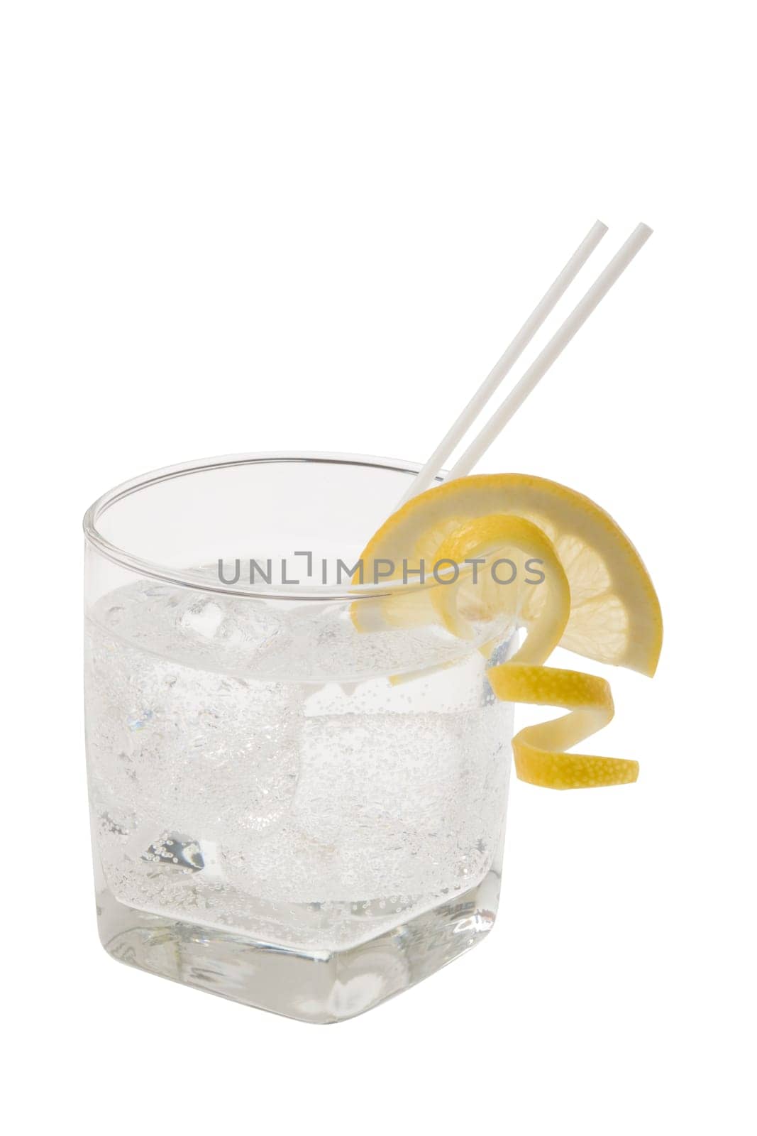 Club soda with lemon slice and peel garnish on white background