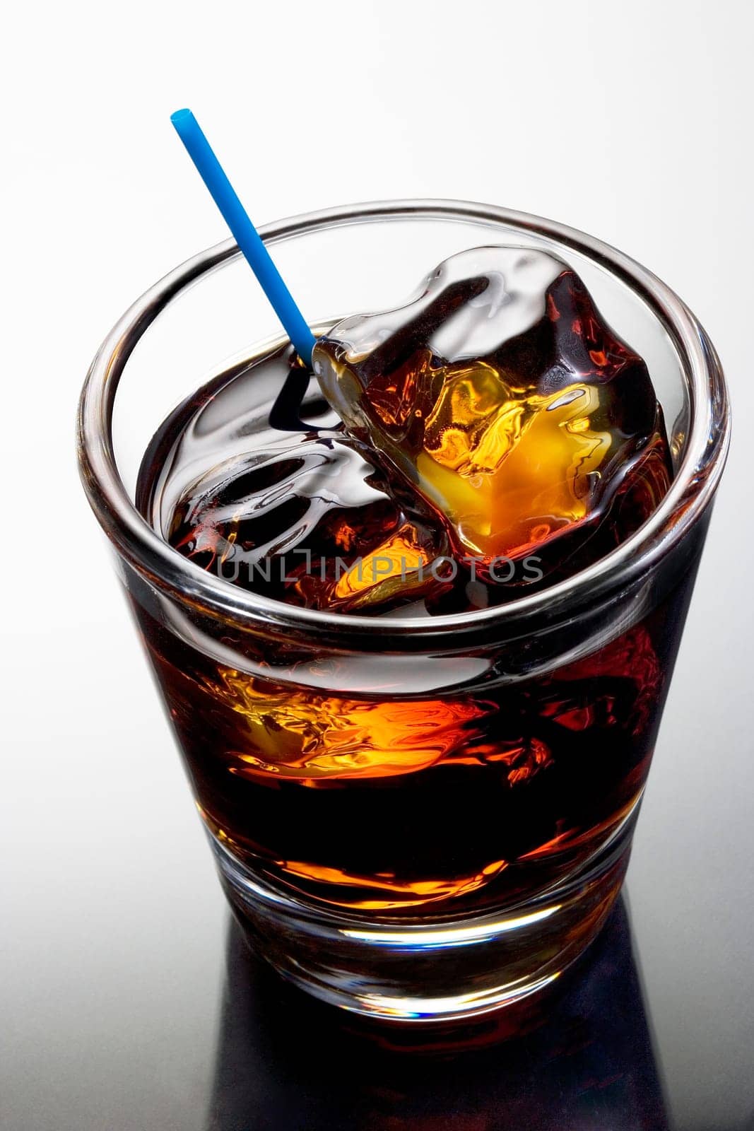 Black Russian mixed drink on a grey background with reflection