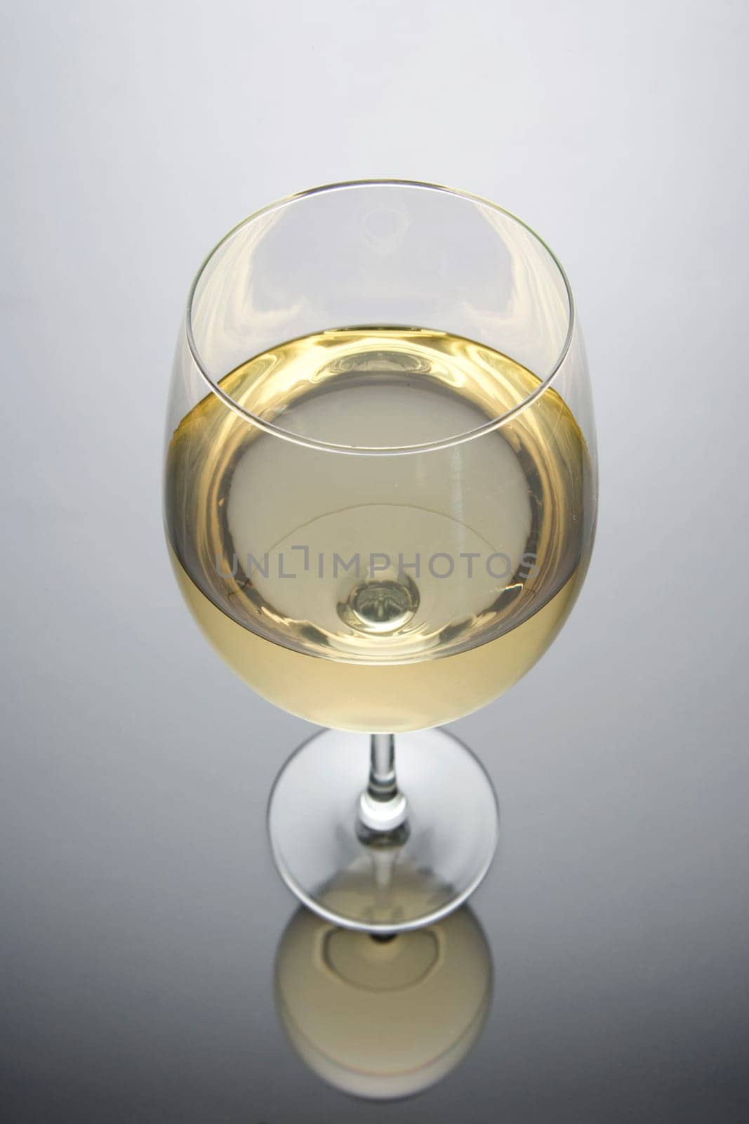 Glass of white wine on a white and black background