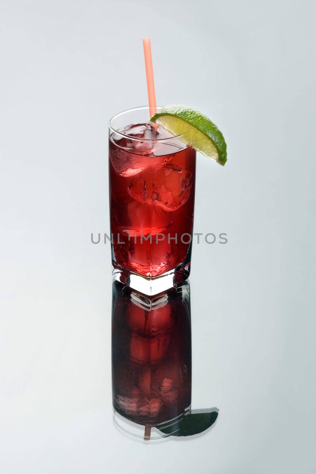 Cape Codder mixed drink on a grey background with reflection