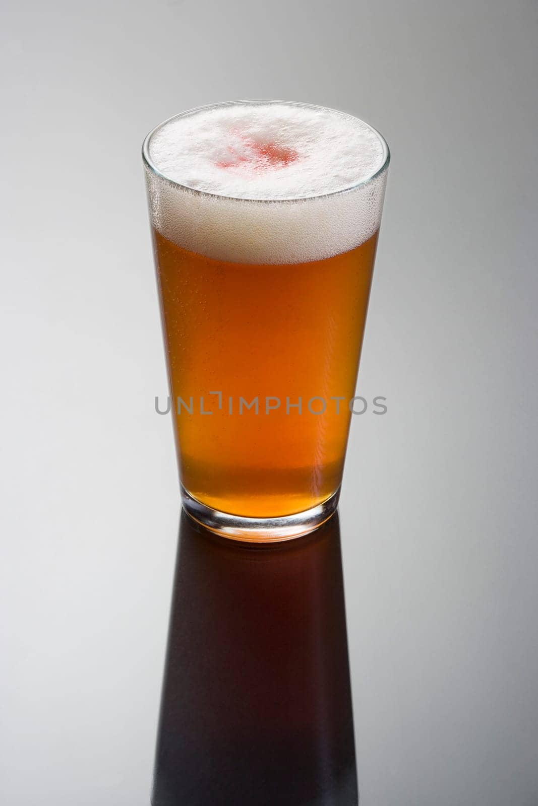 Snake Bite Jack mixed drink on grey background with reflection
