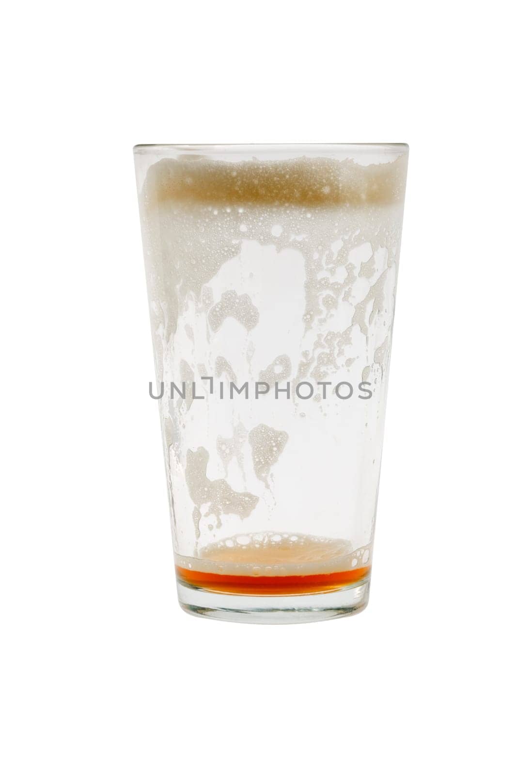 Empty pint glass with foam on white background