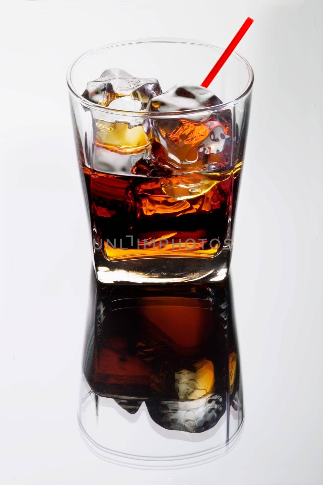 Black Russian mixed drink on a grey background with reflection