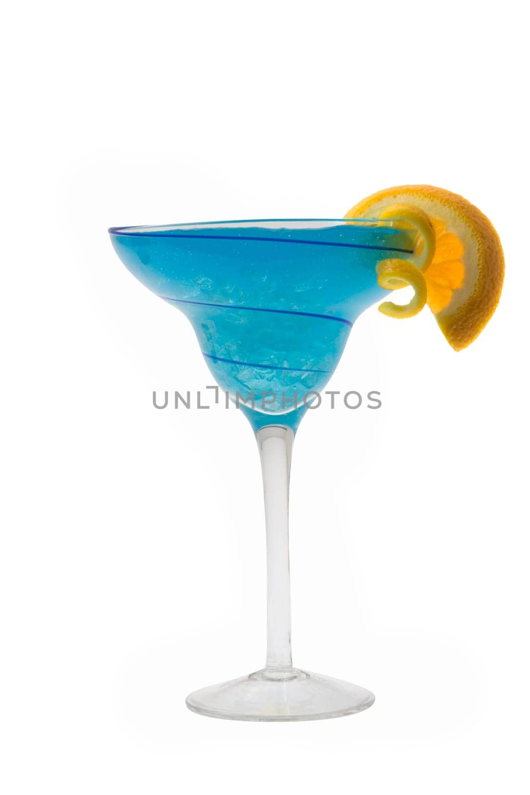 Blue Hawaiian mixed drink with orange and lemon garnish on white background