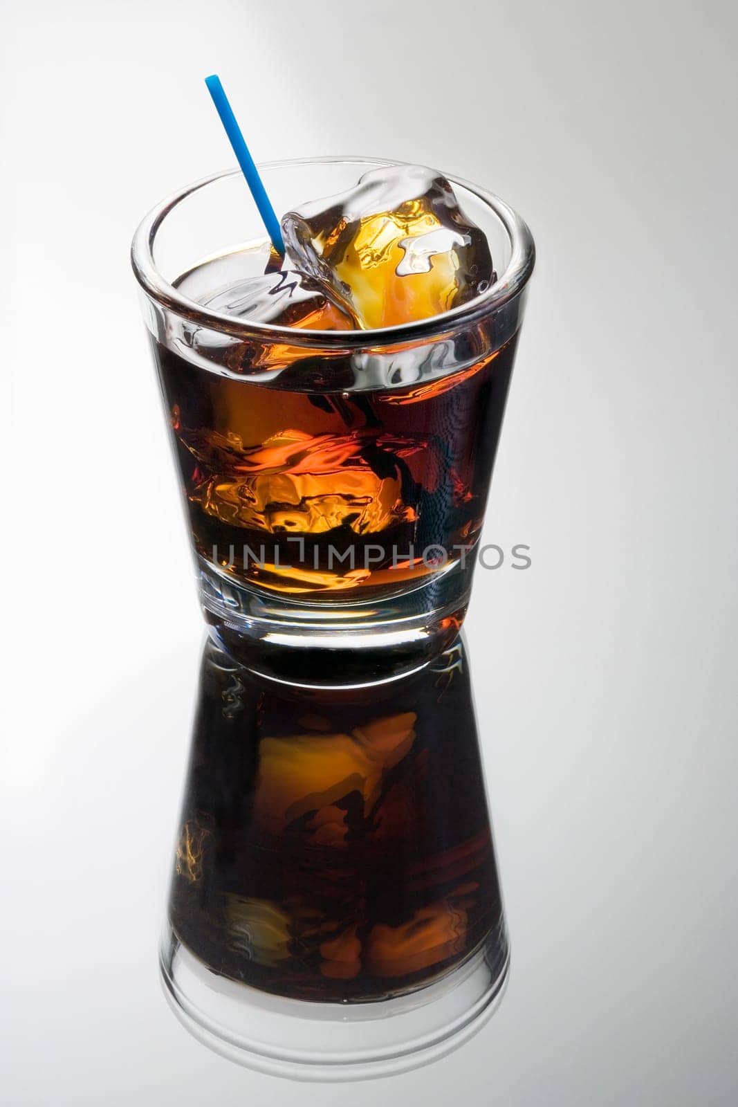 Black Russian mixed drink on a grey background with reflection