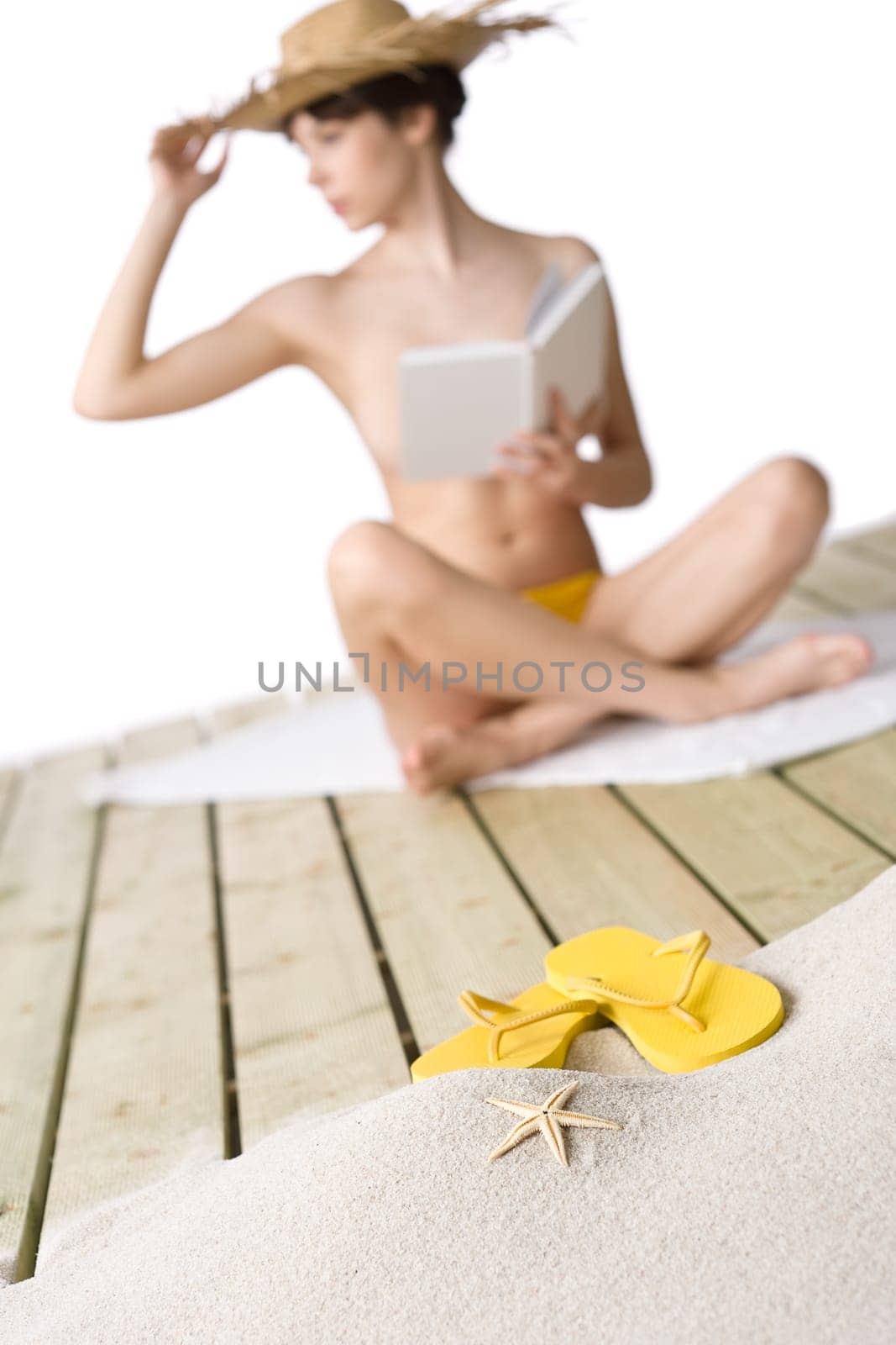 Beach - starfish with flip-flop on sand, woman in background