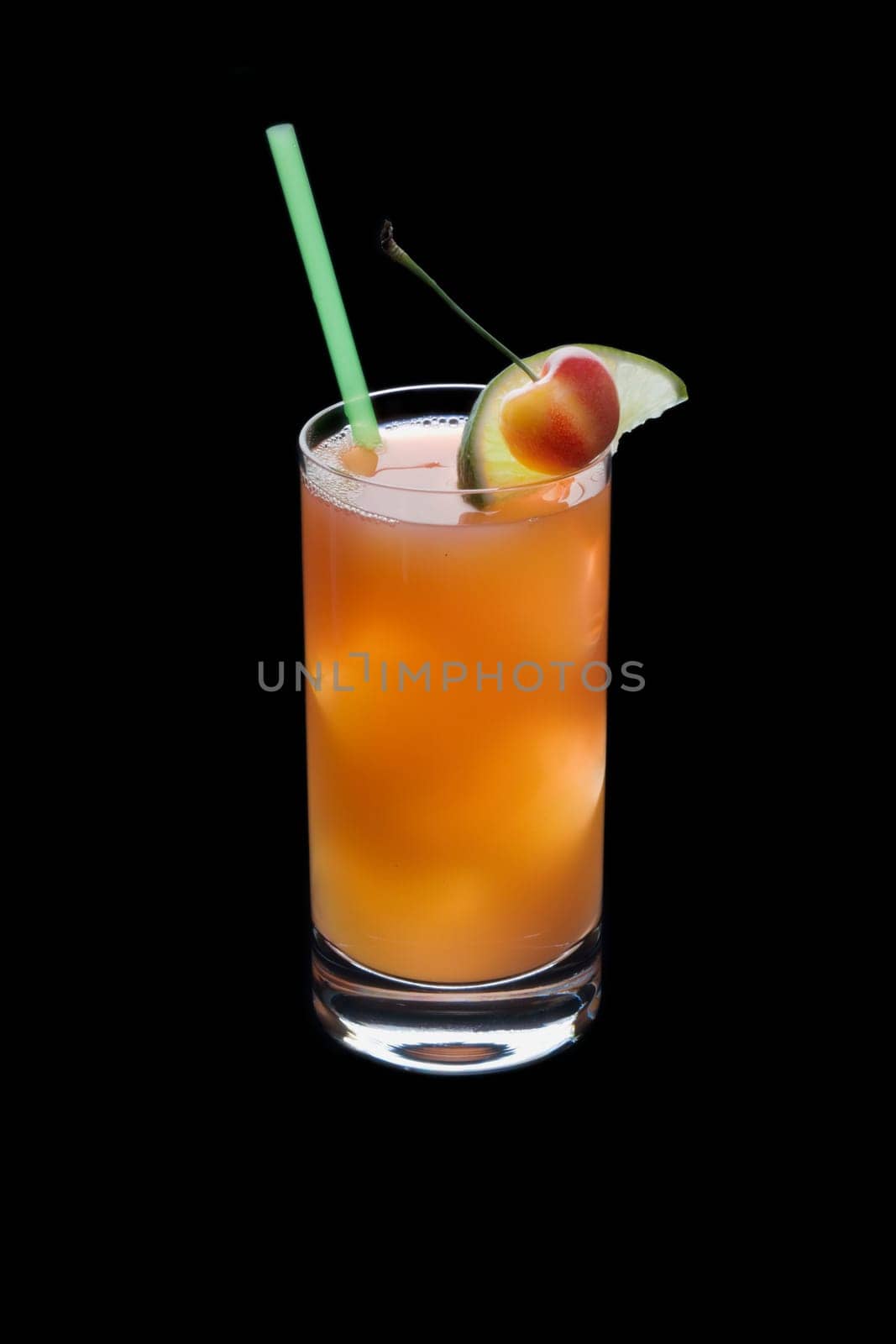 Seabreeze mixed drink with lime and cherry garnish on black background