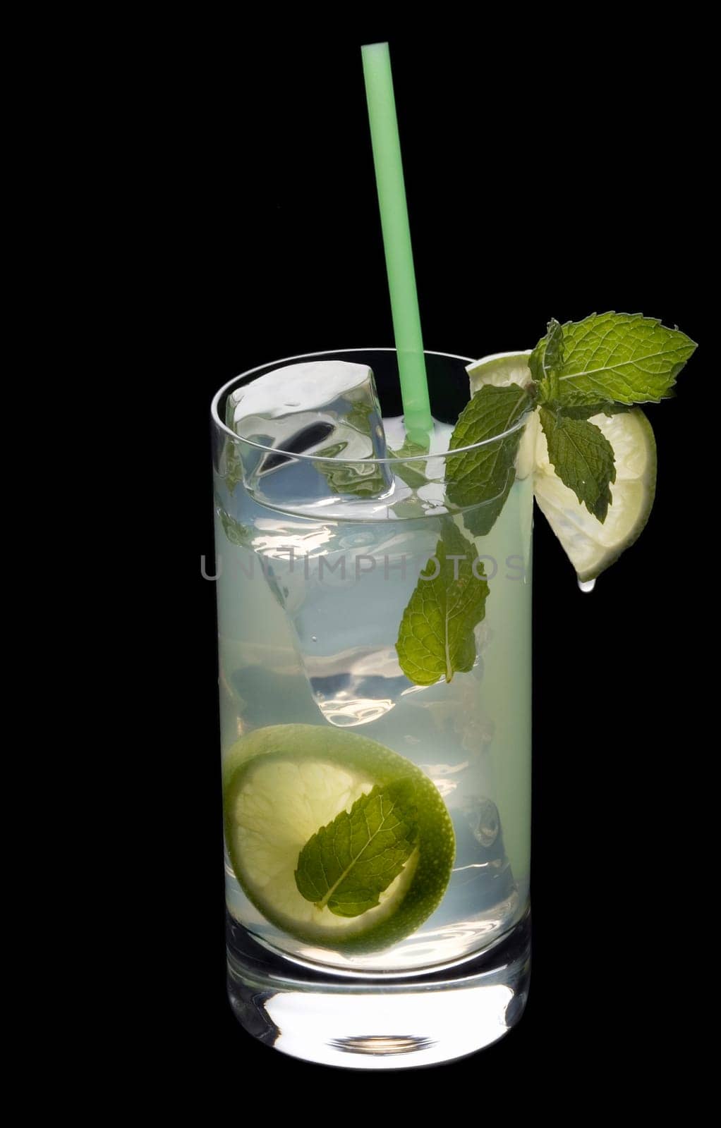 Mojito mixed drink on a plain black background