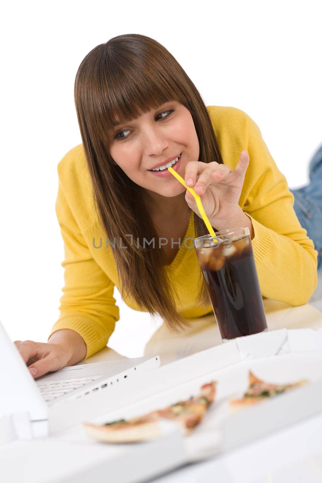 Happy female teenager with laptop lying down