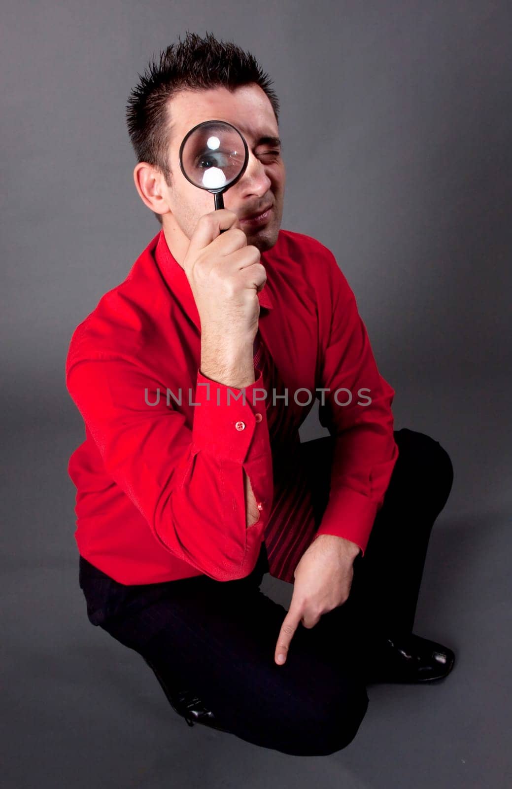 Funny businessman with magnifying glass