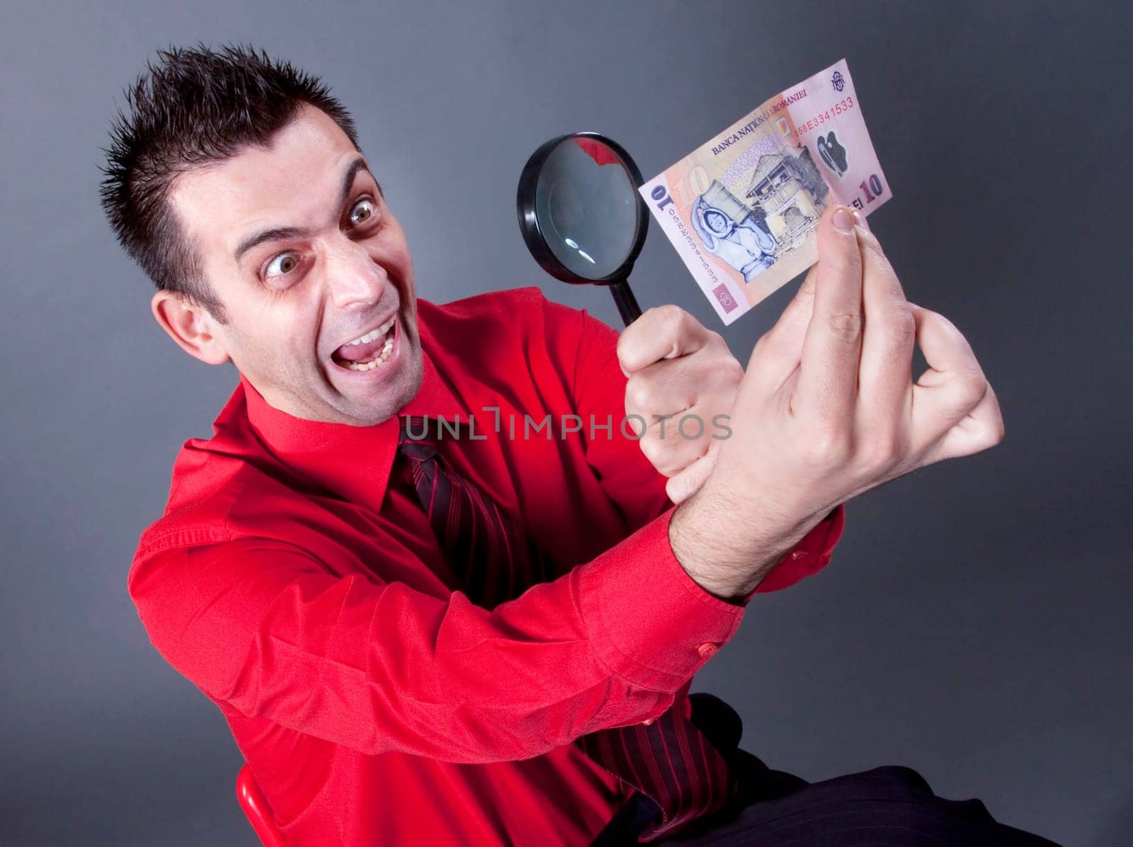 Funny businessman looking at banknote