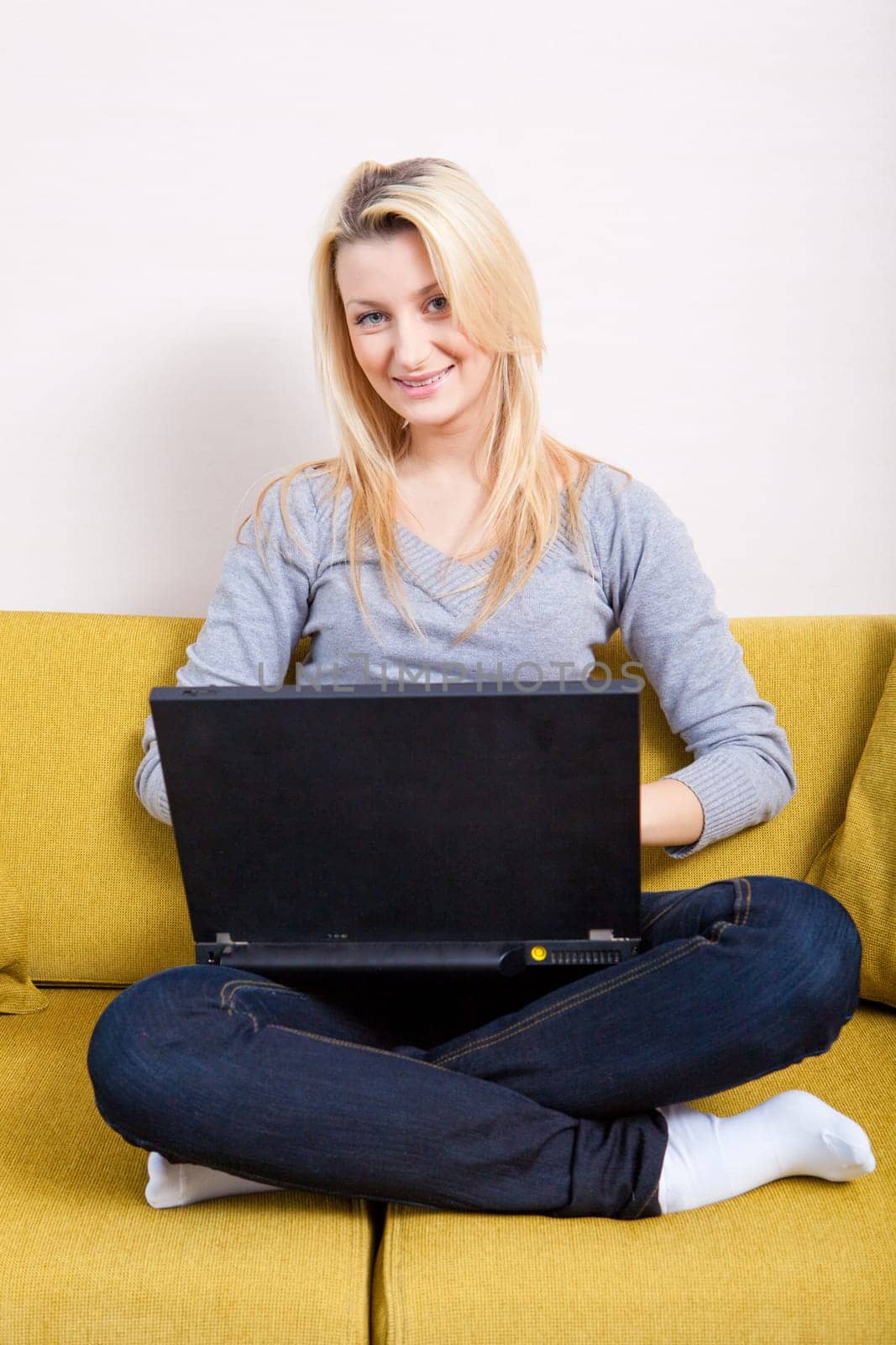 woman sitting on sofa and having coffee