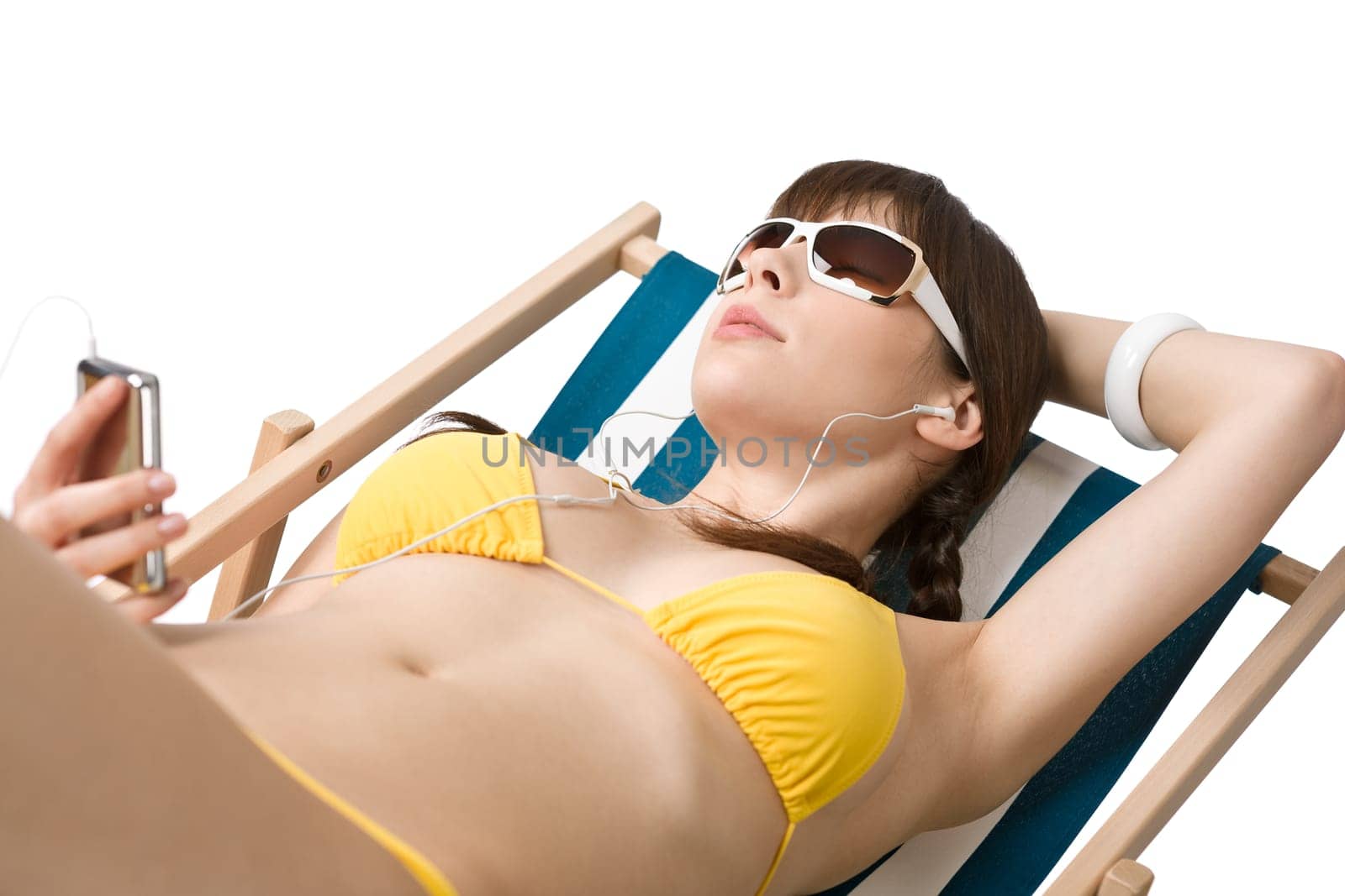Beach - Woman listen to music in bikini sunbathing
