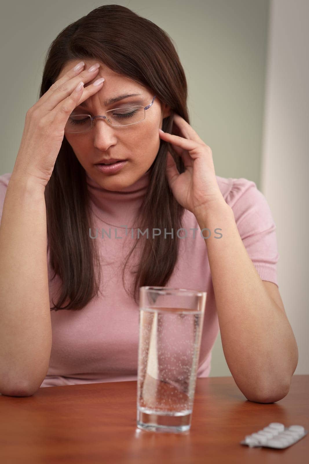 Businesswoman with headache take pill at office