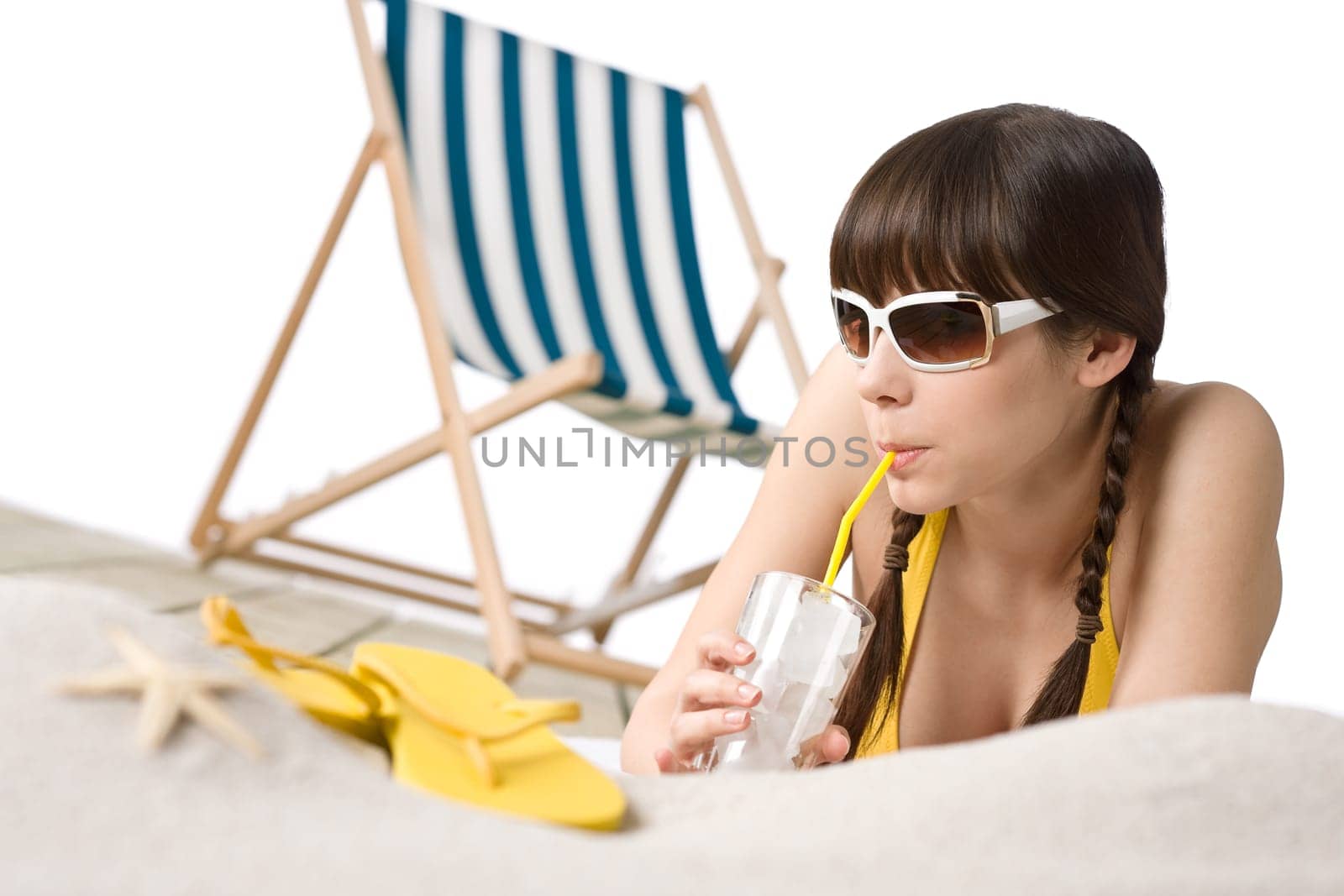 Beach - Woman in bikini with drink and flip-flop on sand