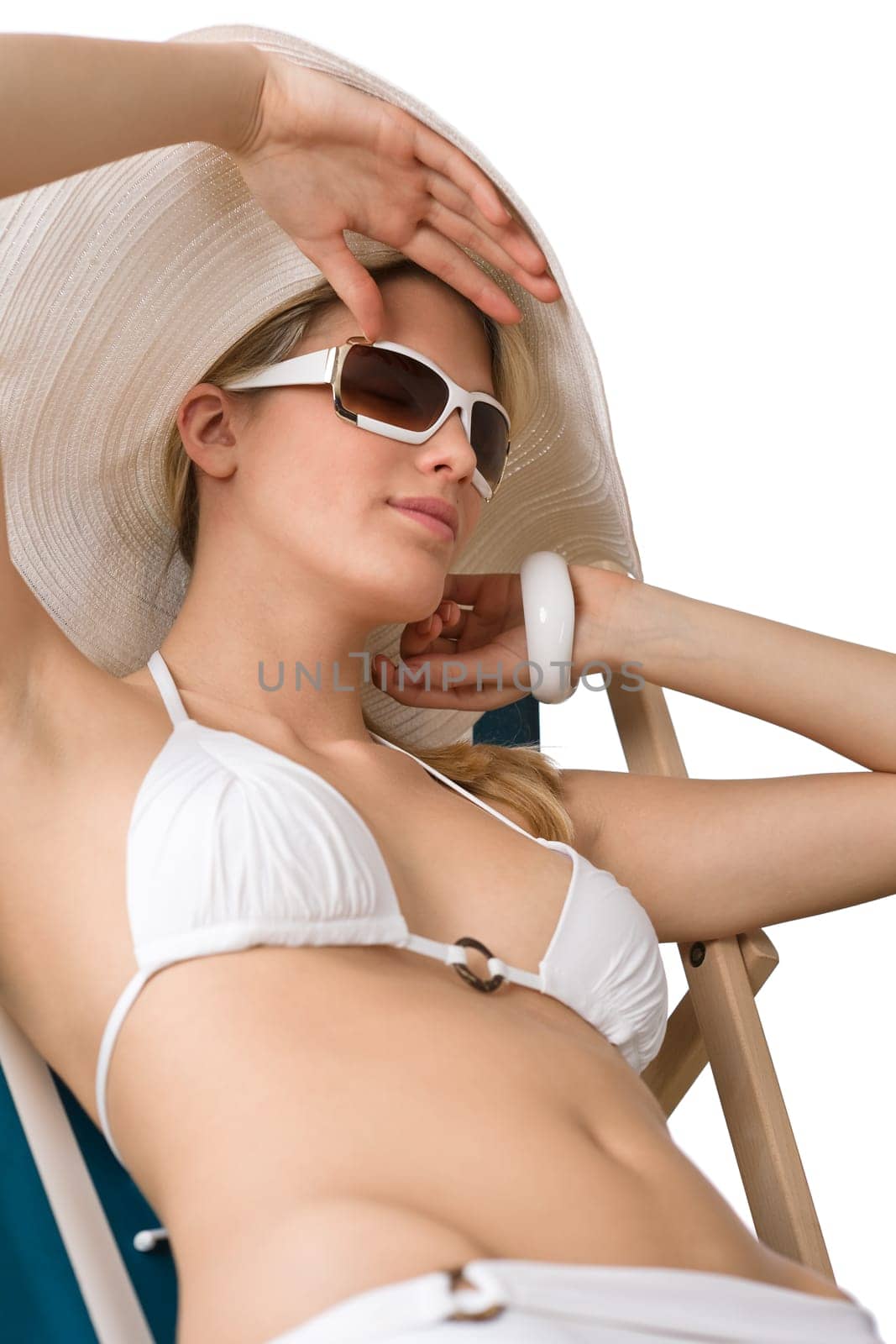 Beach - woman in bikini with hat sunbathing
