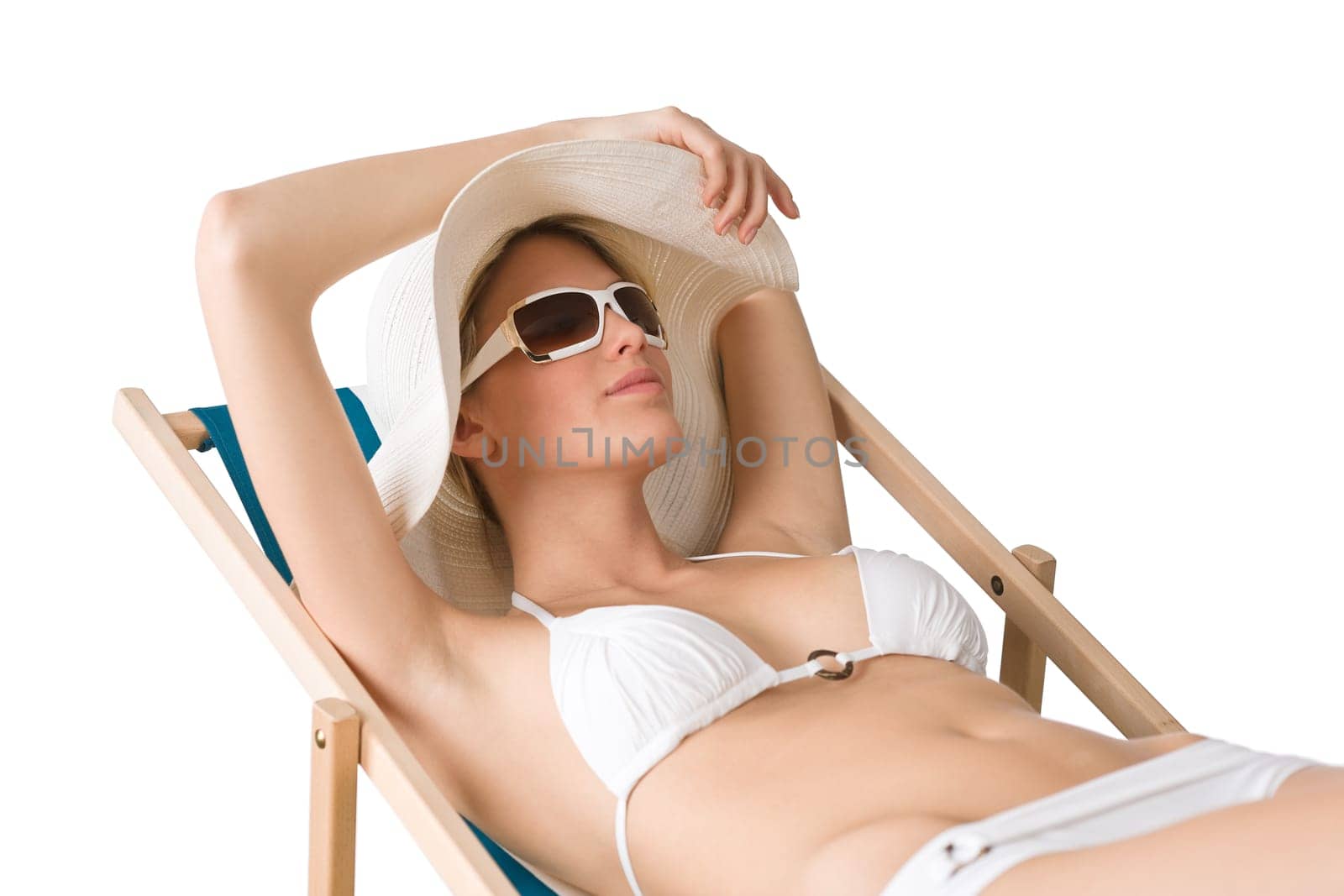 Beach - woman in bikini with hat sunbathing