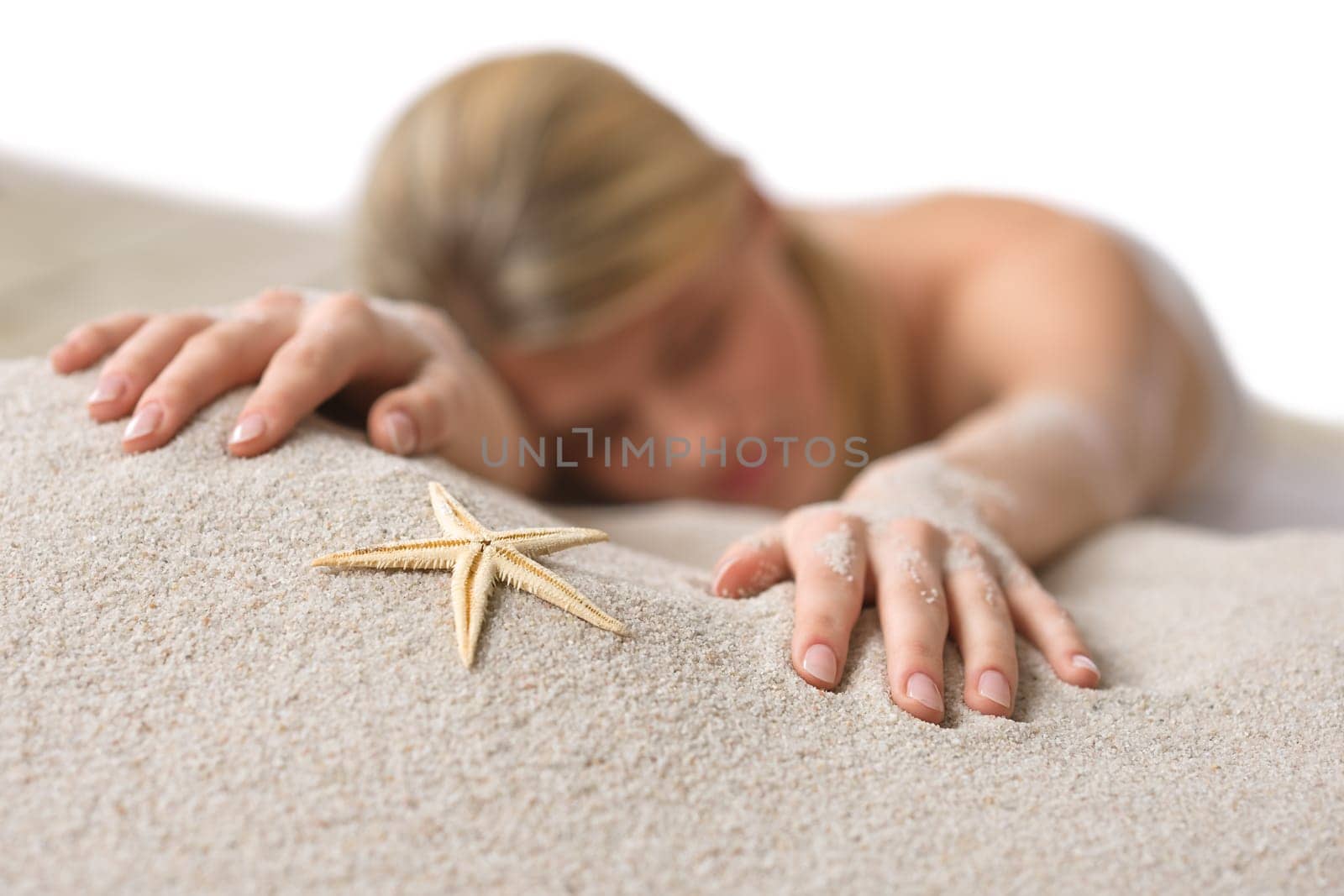 Beach - woman with starfish on sand
