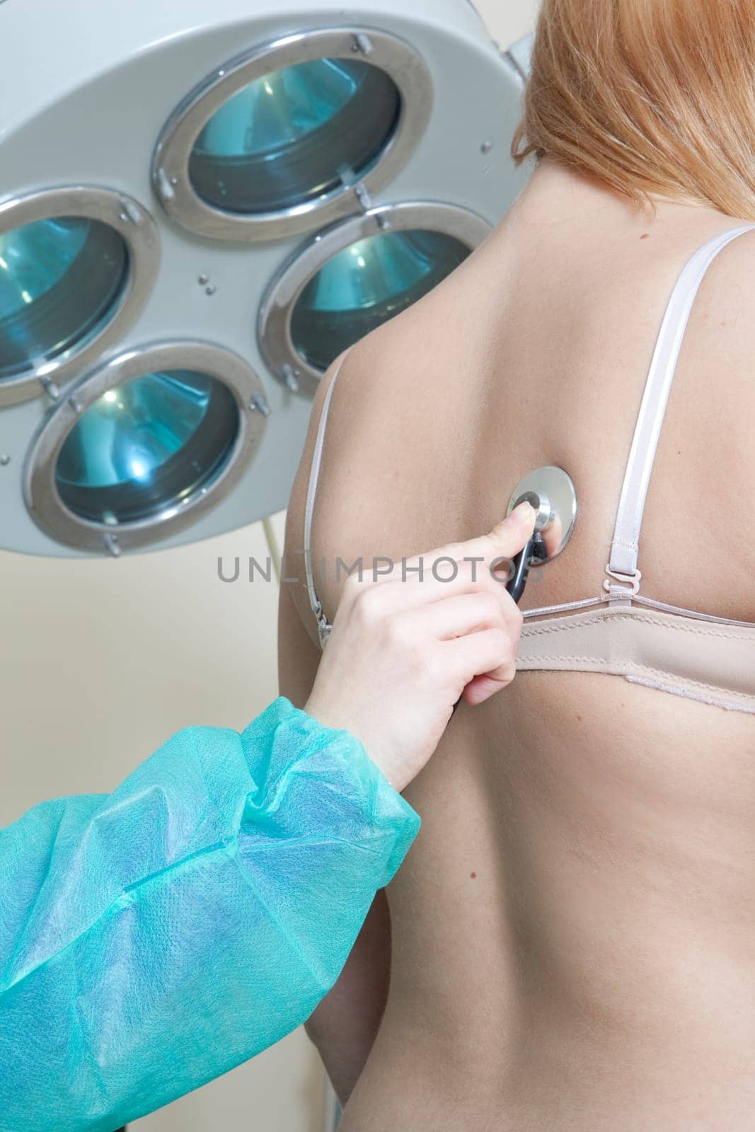 doctor listening to patients heartbeat