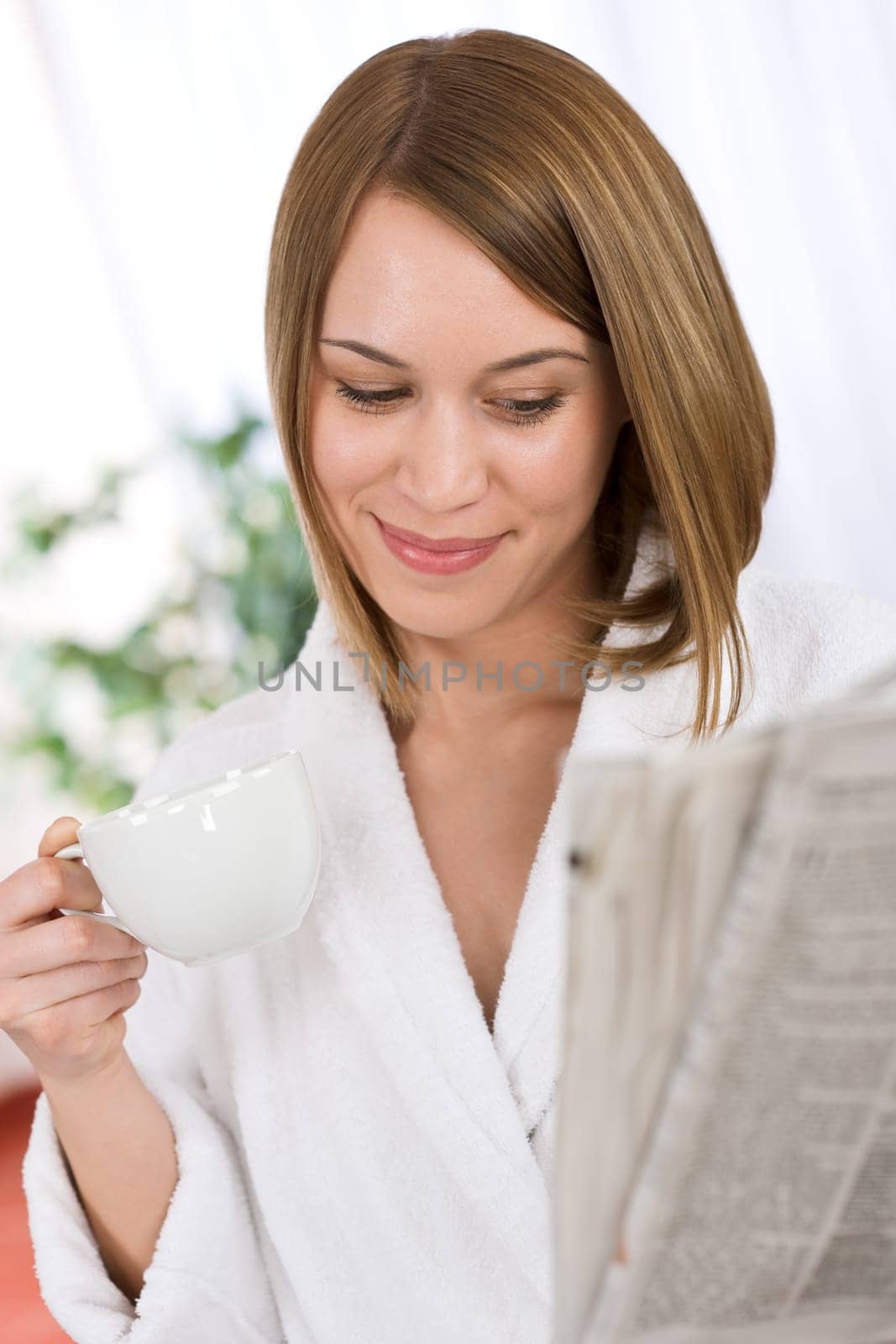 Breakfast - happy woman reading newspaper drink coffee