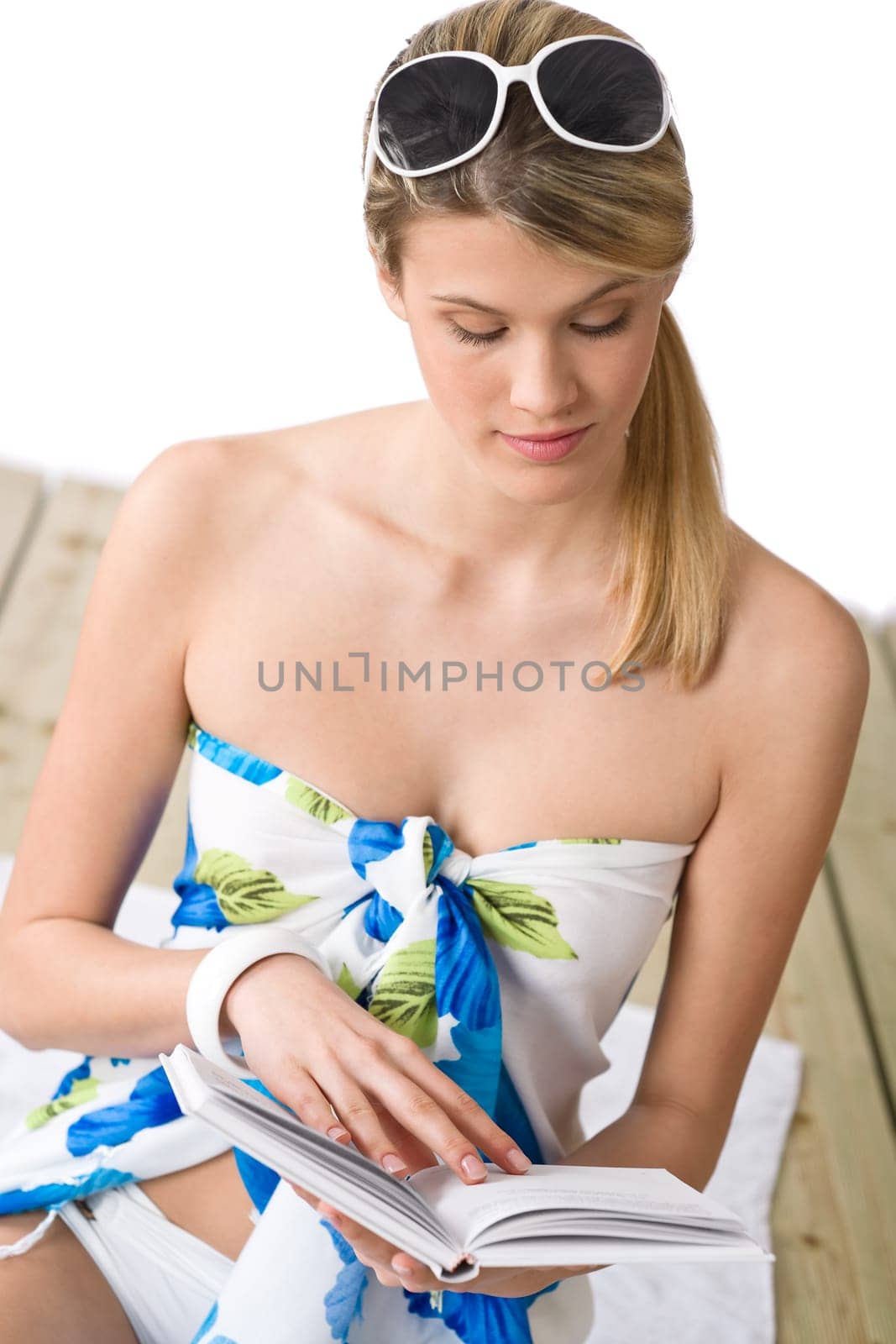 Beach - woman sitting with book, sunbathing