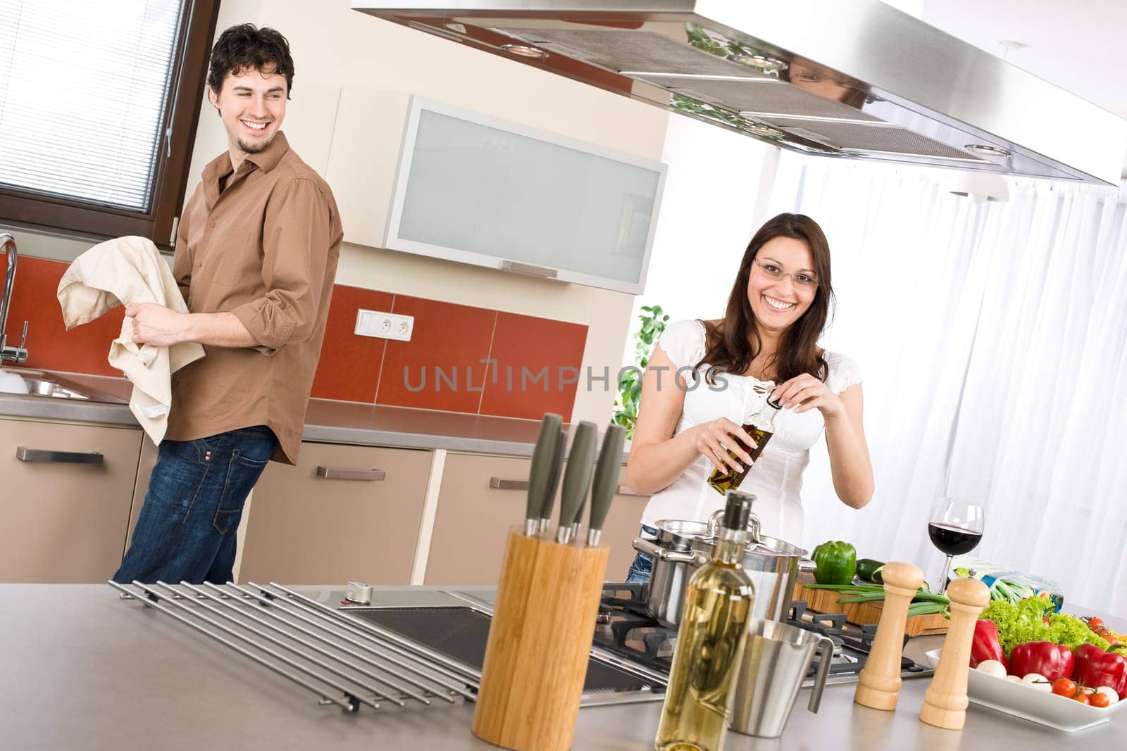 Cooking - happy couple together in modern kitchen