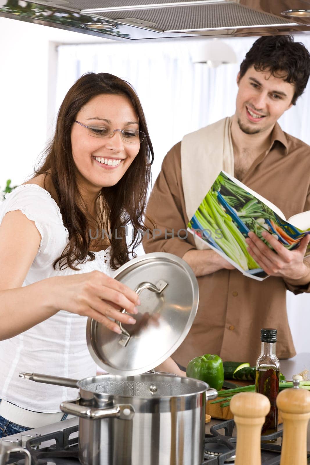 Cooking - happy couple together in modern kitchen