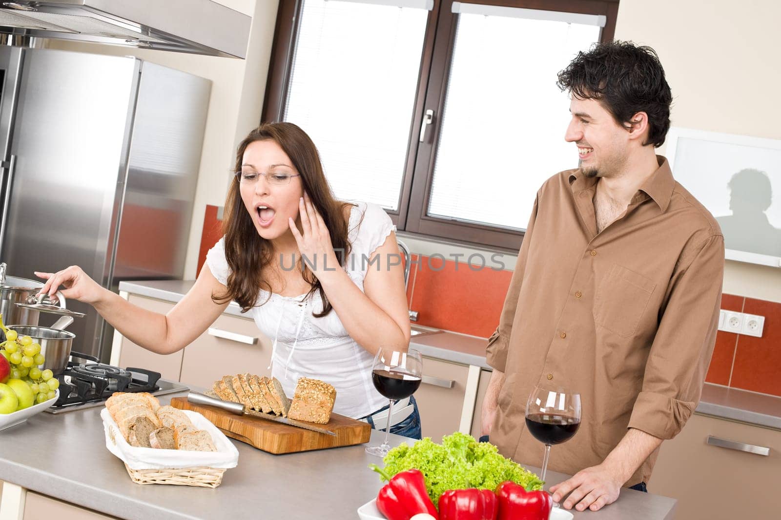 Cooking - happy couple in modern kitchen