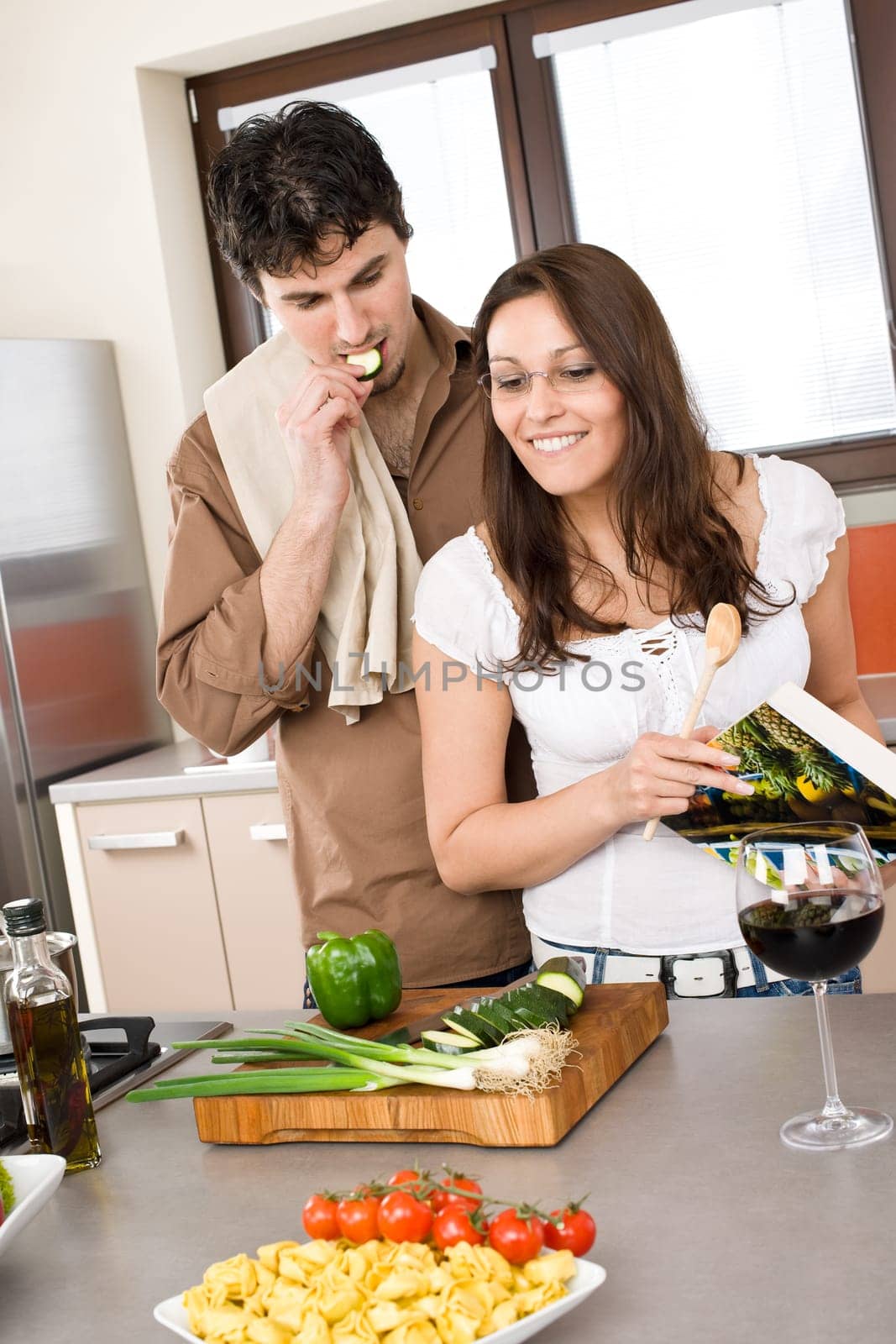 Cooking - happy couple together in modern kitchen