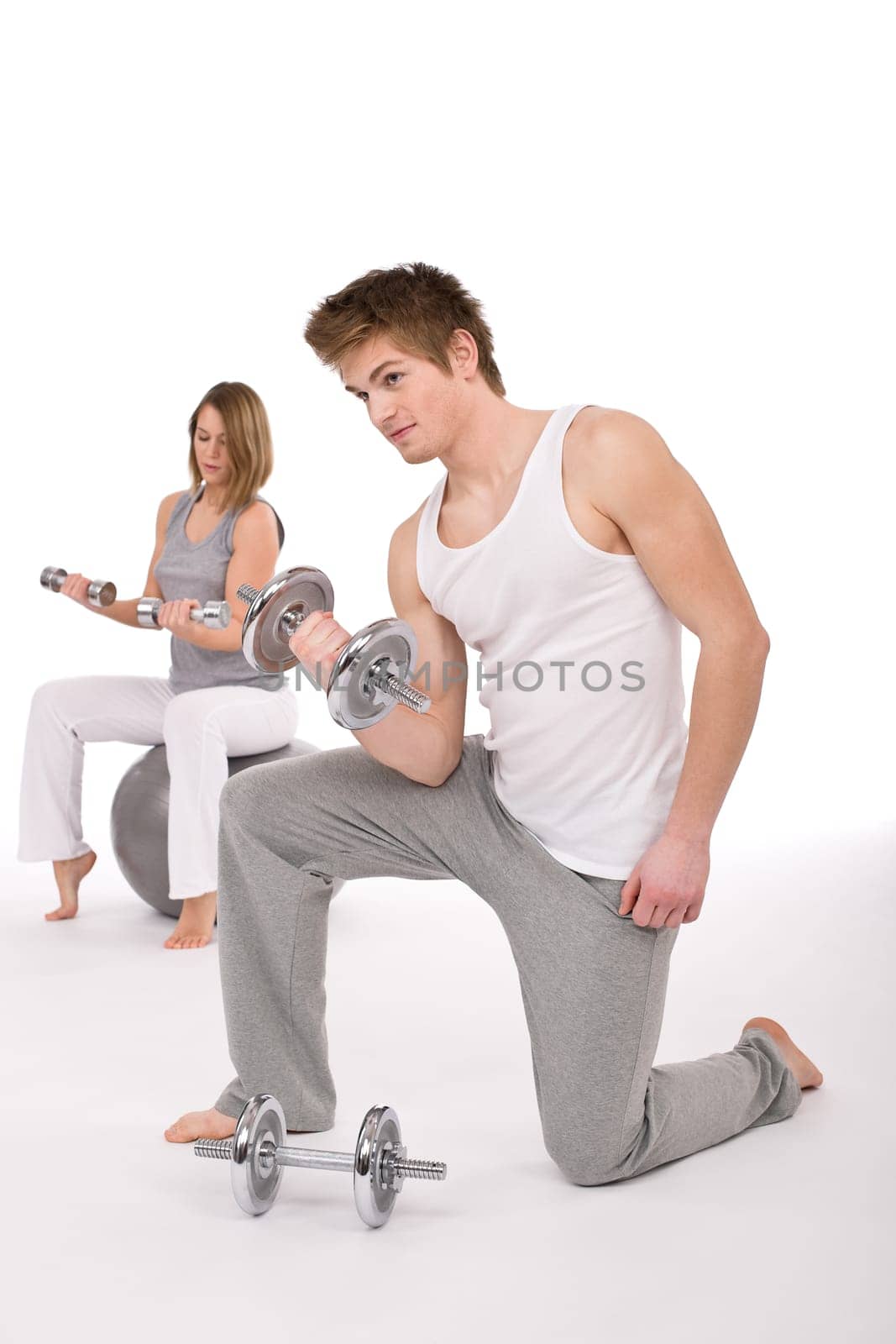 Fitness - Young couple exercise with weights