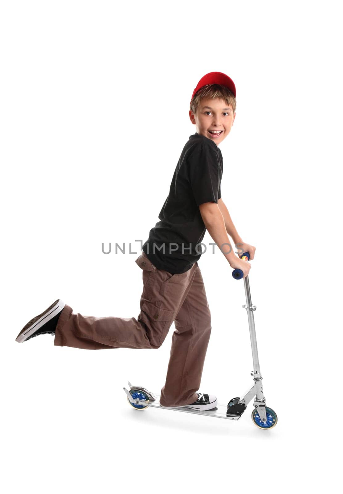 Child riding a scooter and smiling