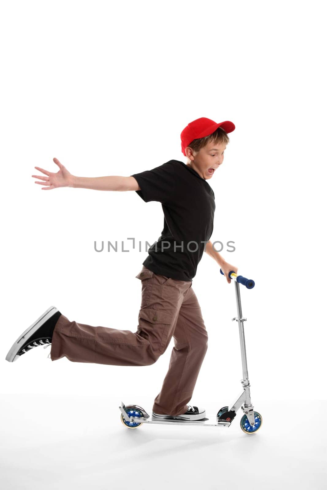Happy boy riding a scooter