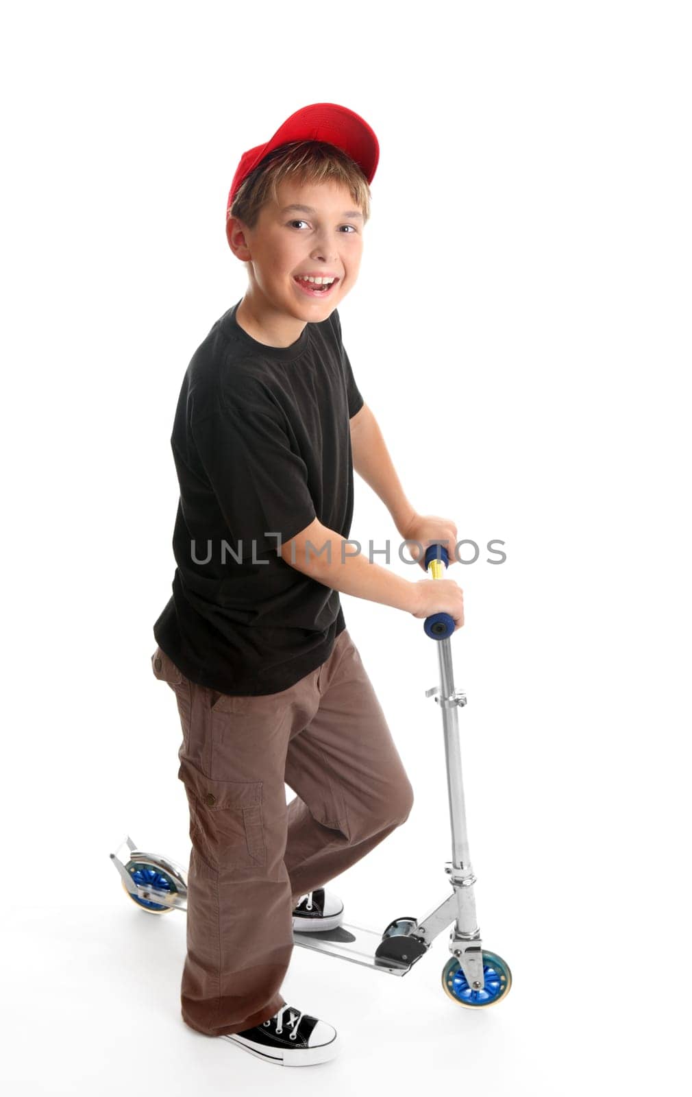 Boy standing beside a scooter