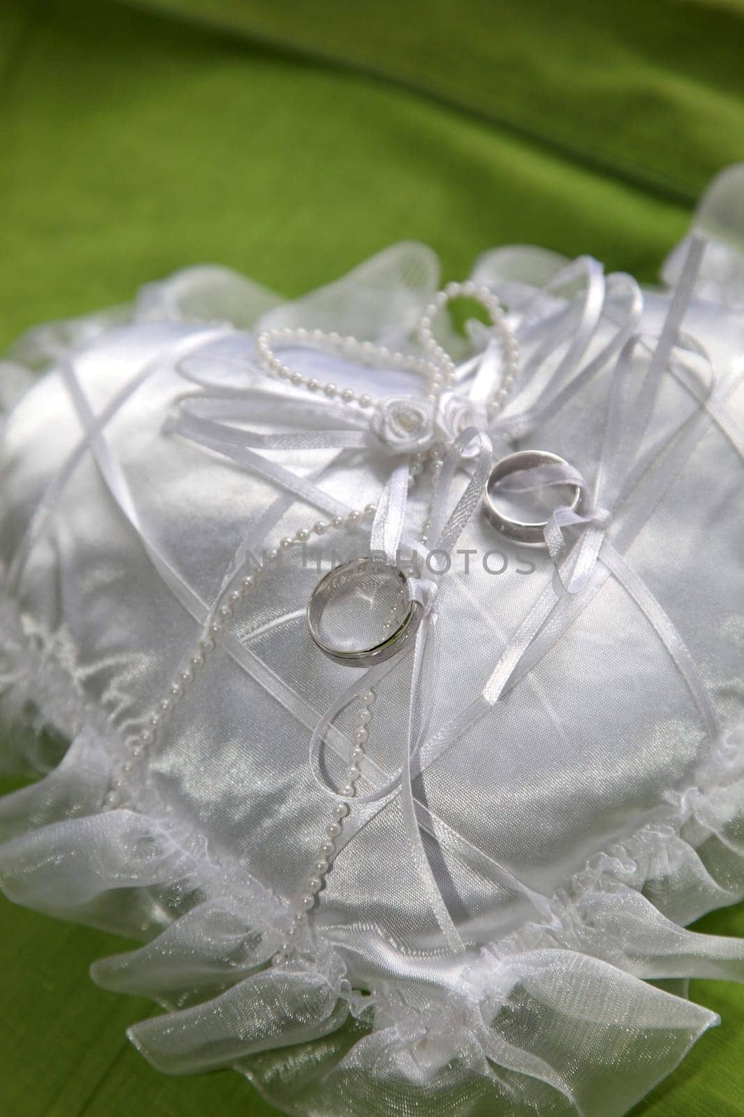 wedding rings on a white ring pillow