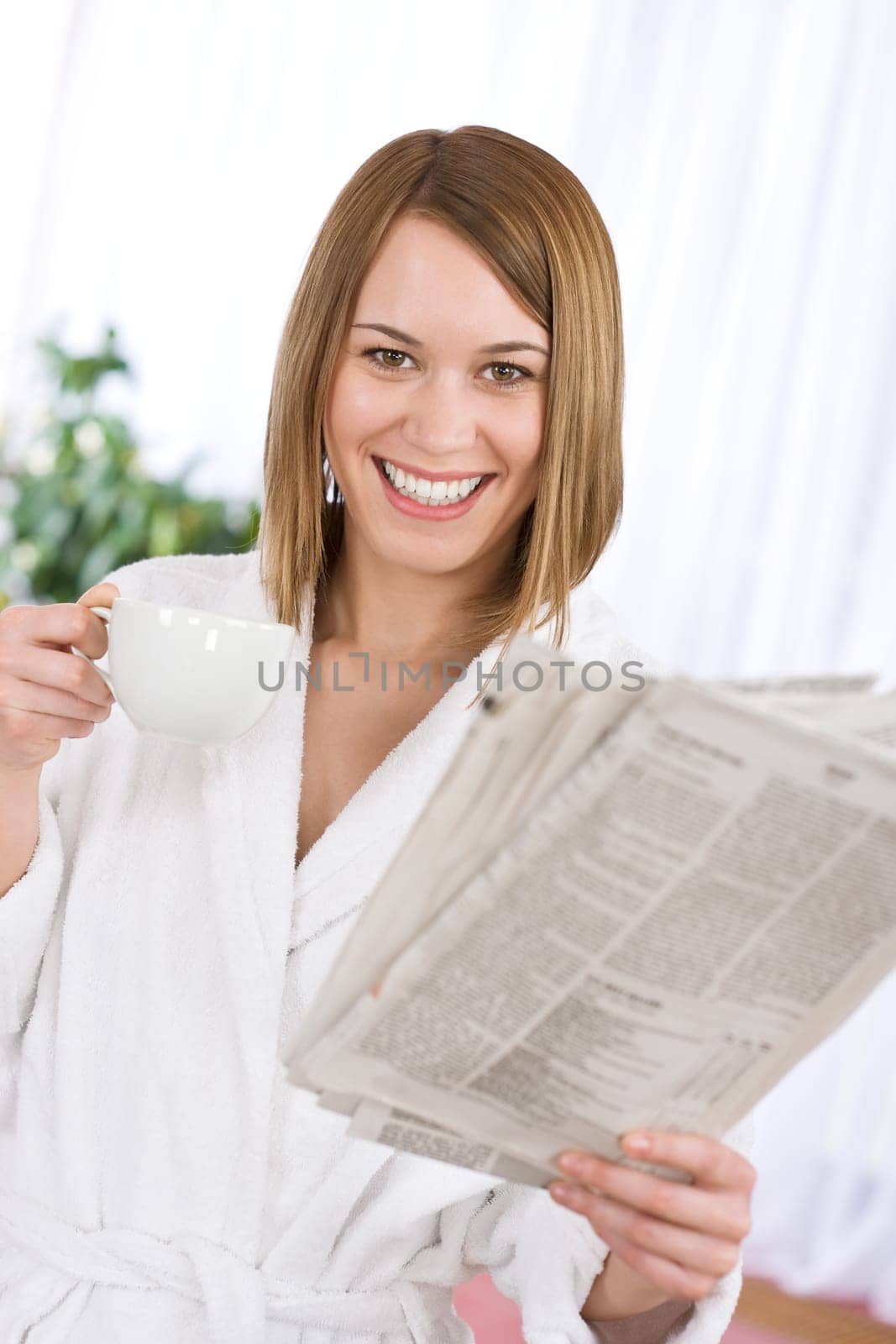 Breakfast - happy woman reading newspaper drink coffee