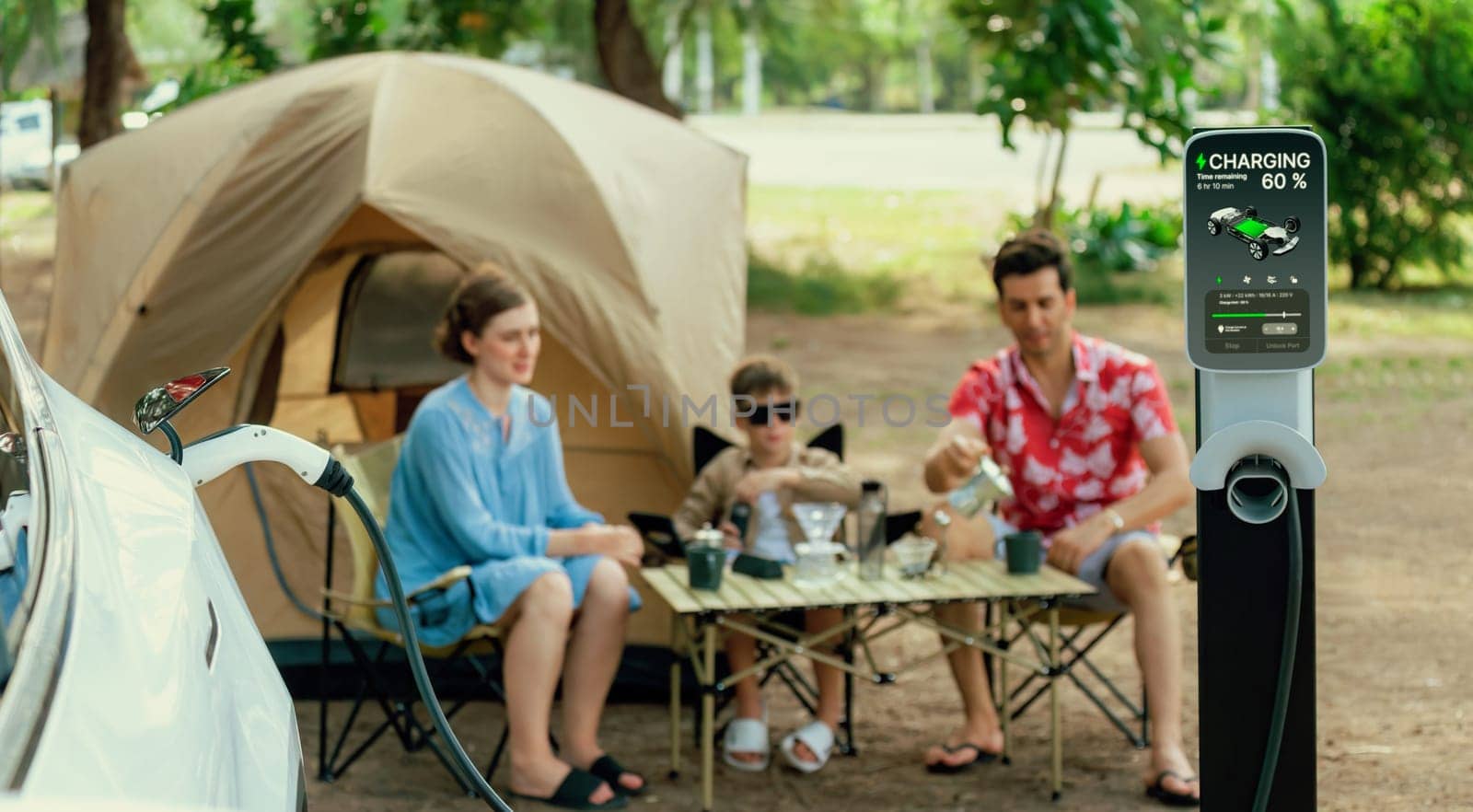 Outdoor adventure and family vacation camping in nature travel by eco friendly car for sustainable future. Lovely sit on trunk, charging EV car with EV charging station in campsite. Panorama Perpetual