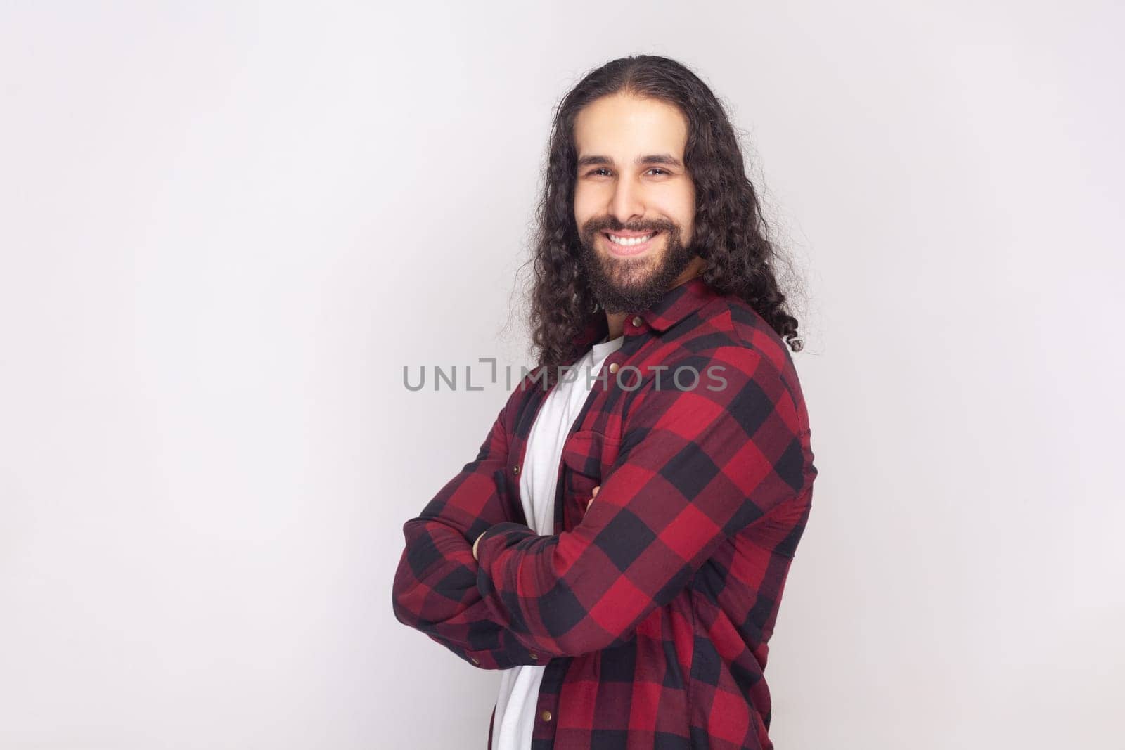 Smiling happy bearded man standing with crossed arms, expressing confidence. by Khosro1