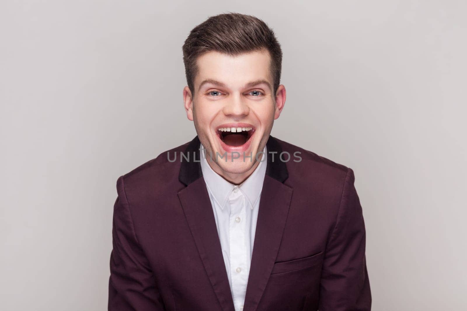 Hndsome man laughs at something funny, looking at camera, having fun, expressing positive emotions, by Khosro1