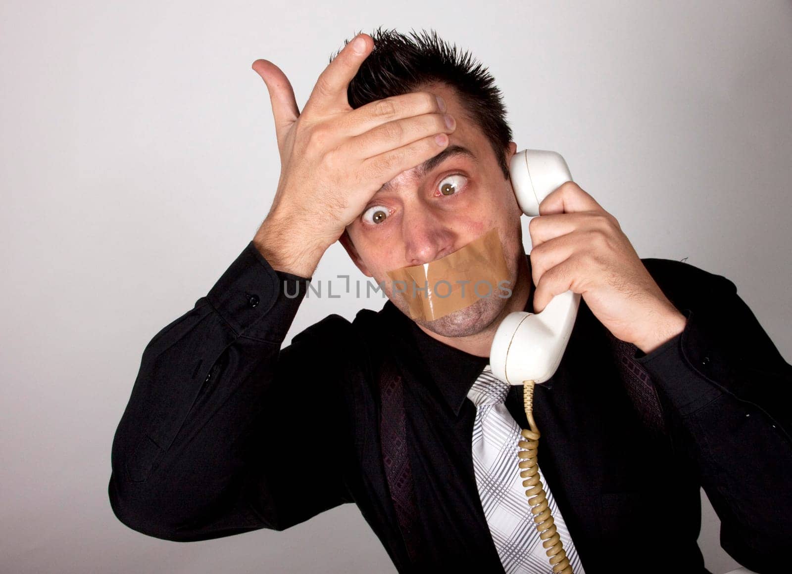 Funny businessman with tape on his mouth