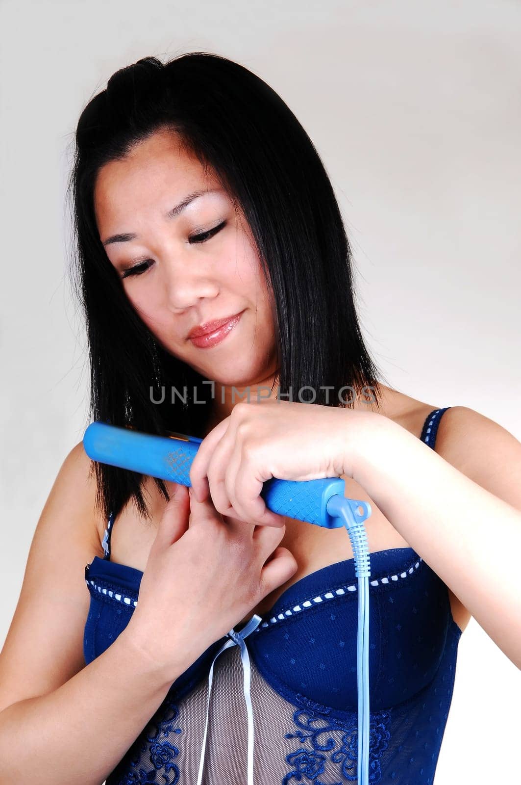 Young Asian girl fixing her hair.