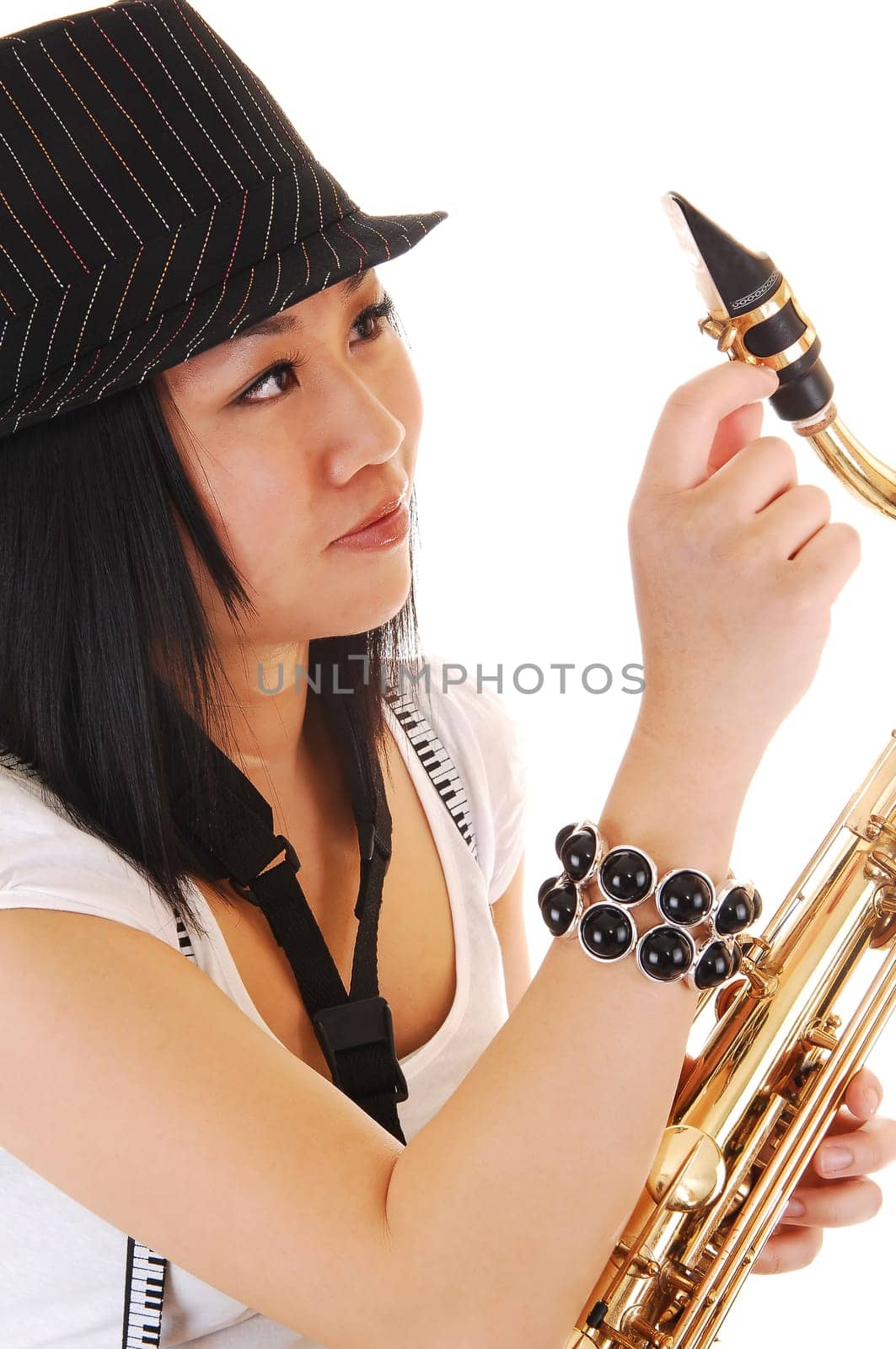 Chinese girl fixing the saxophone.